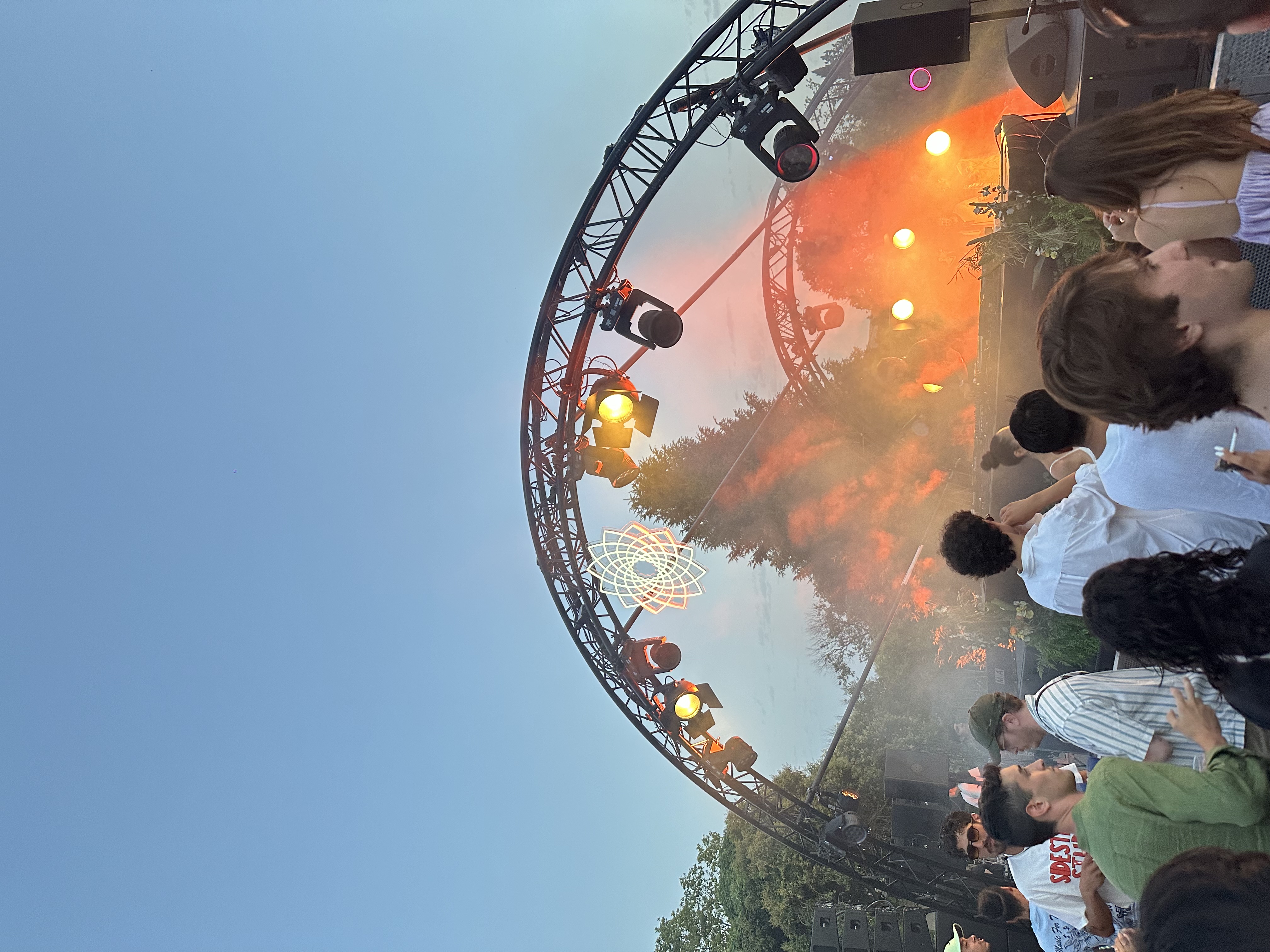 A view of a music concert at dusk.