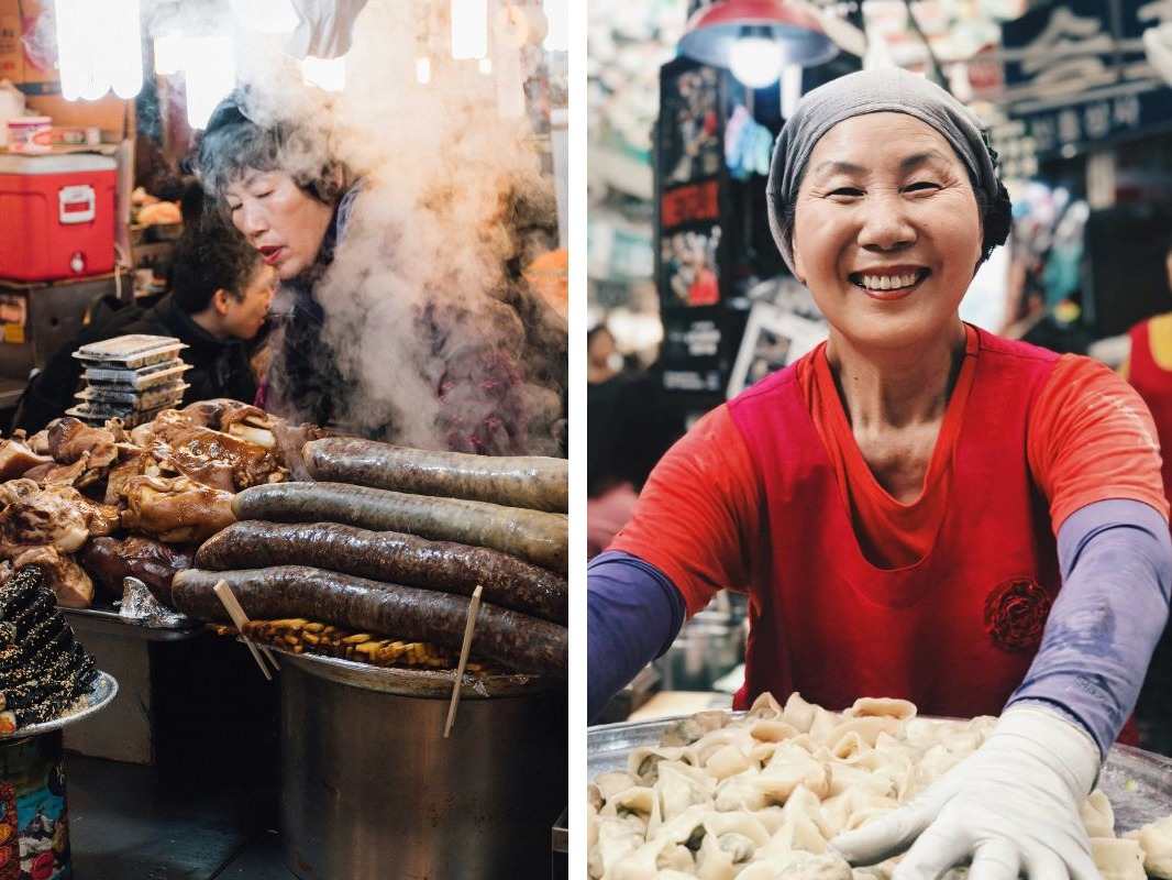 A bustling food market scene with a vendor preparing dumplings and an array of cooked meats on display.