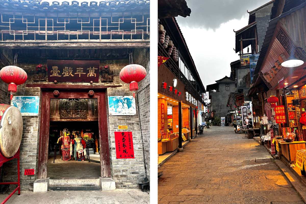 A view looking down a city street with red lanterns and traditional buildings on either side on a cloudy day.