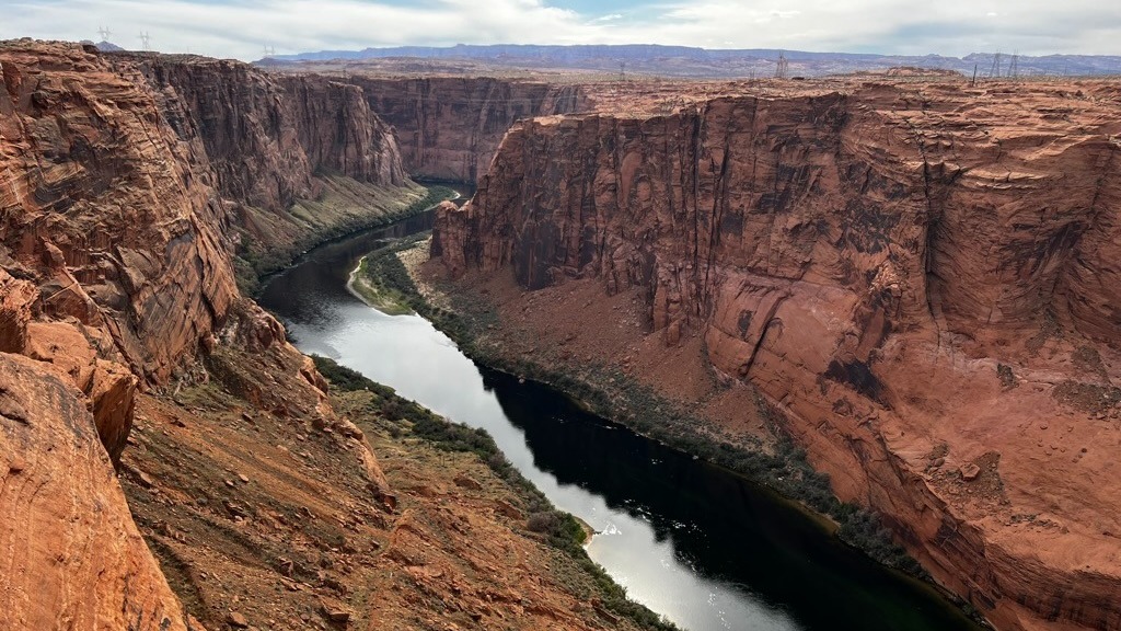 View overlooking the Colorado River through steep red canyon walls.