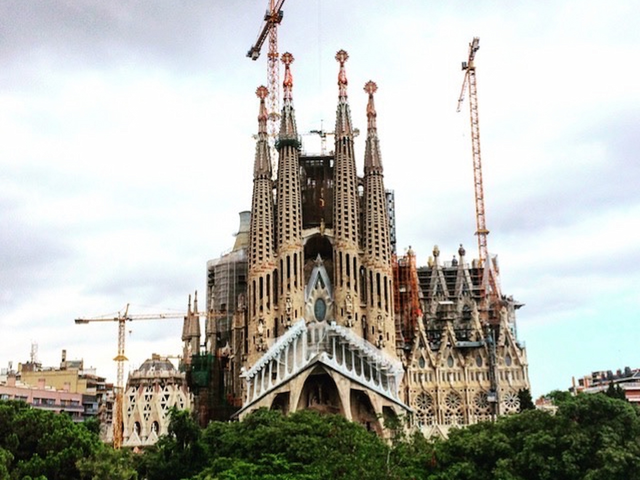 A large, gothic-style cathedral building under construction during the daytime