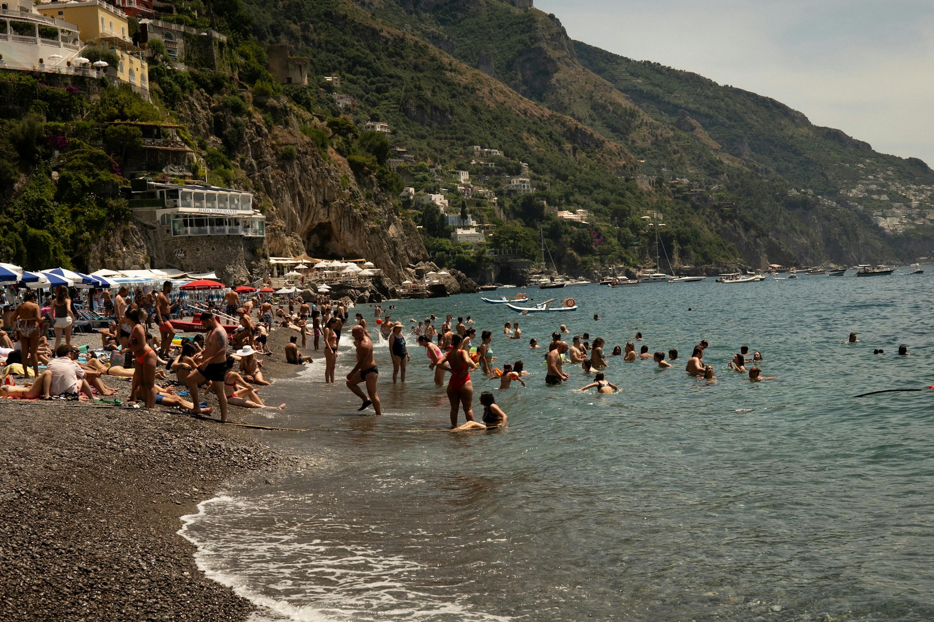 A group of people at the beach during the daytime