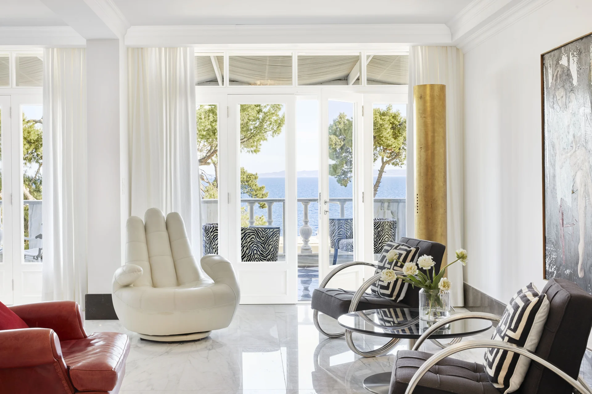 a fancy hotel room with a terrace overlooking the ocean