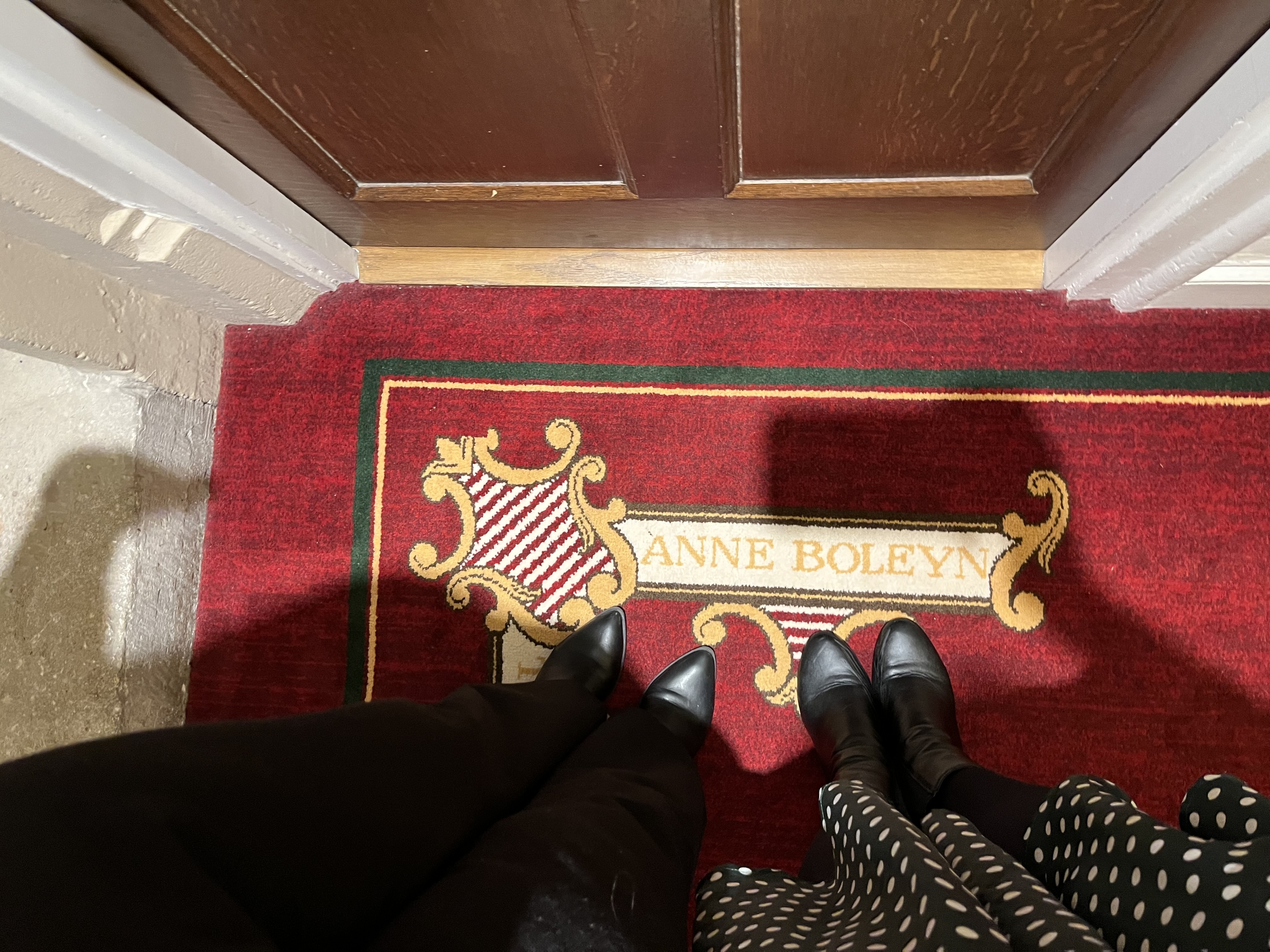 View of an Anne Boleyn rug in front of a door.