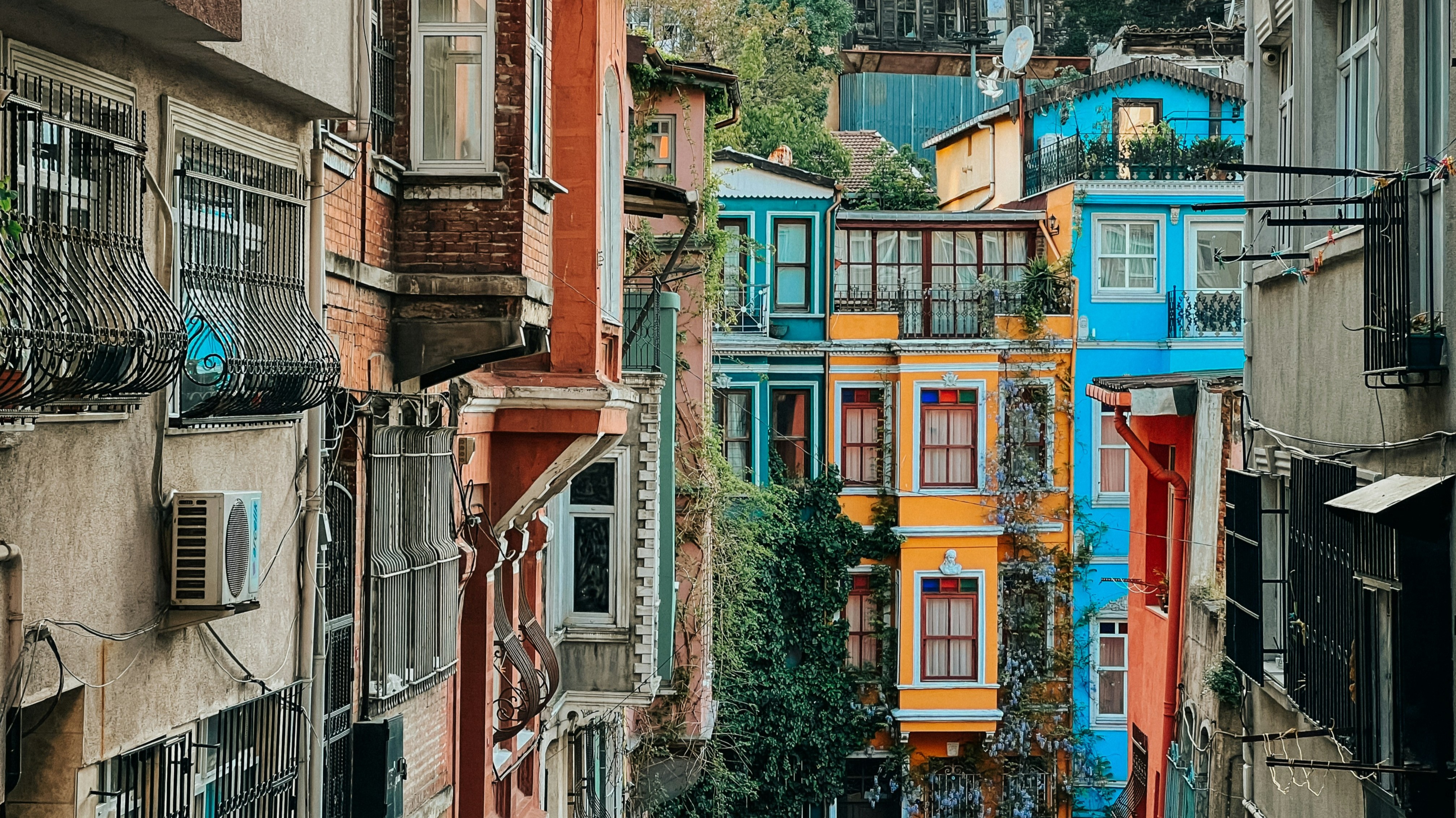 A vibrant street scene with multicolored buildings and dense urban housing.