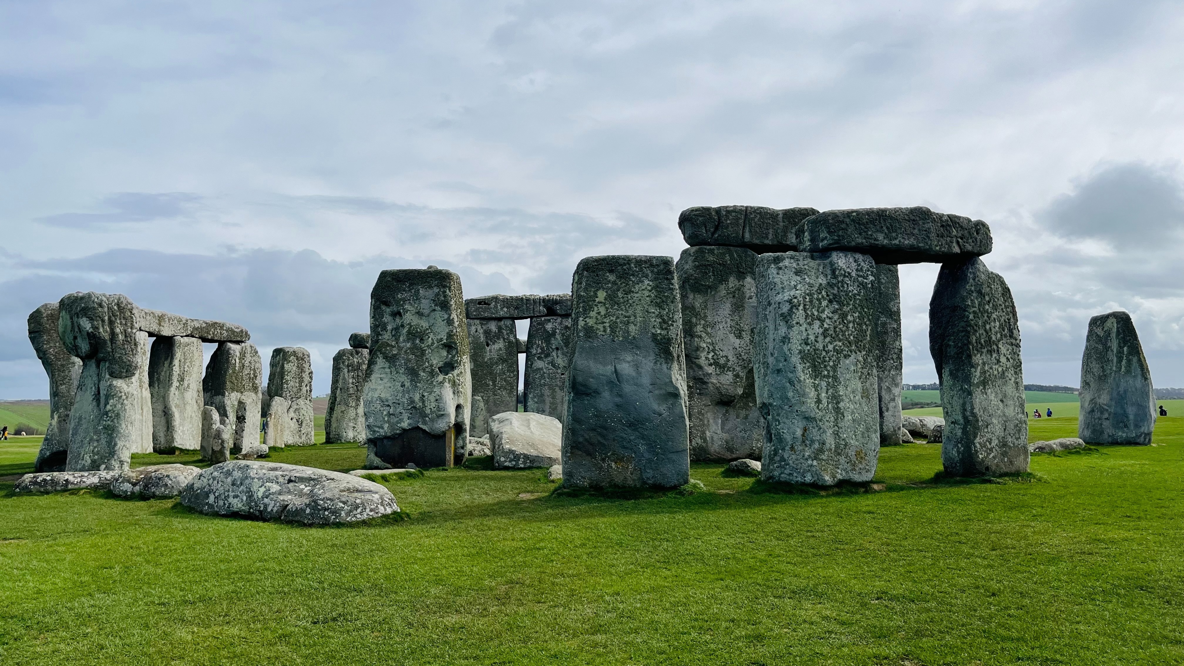 A ring of standing rocks on a grassy hill at Stonehenge.