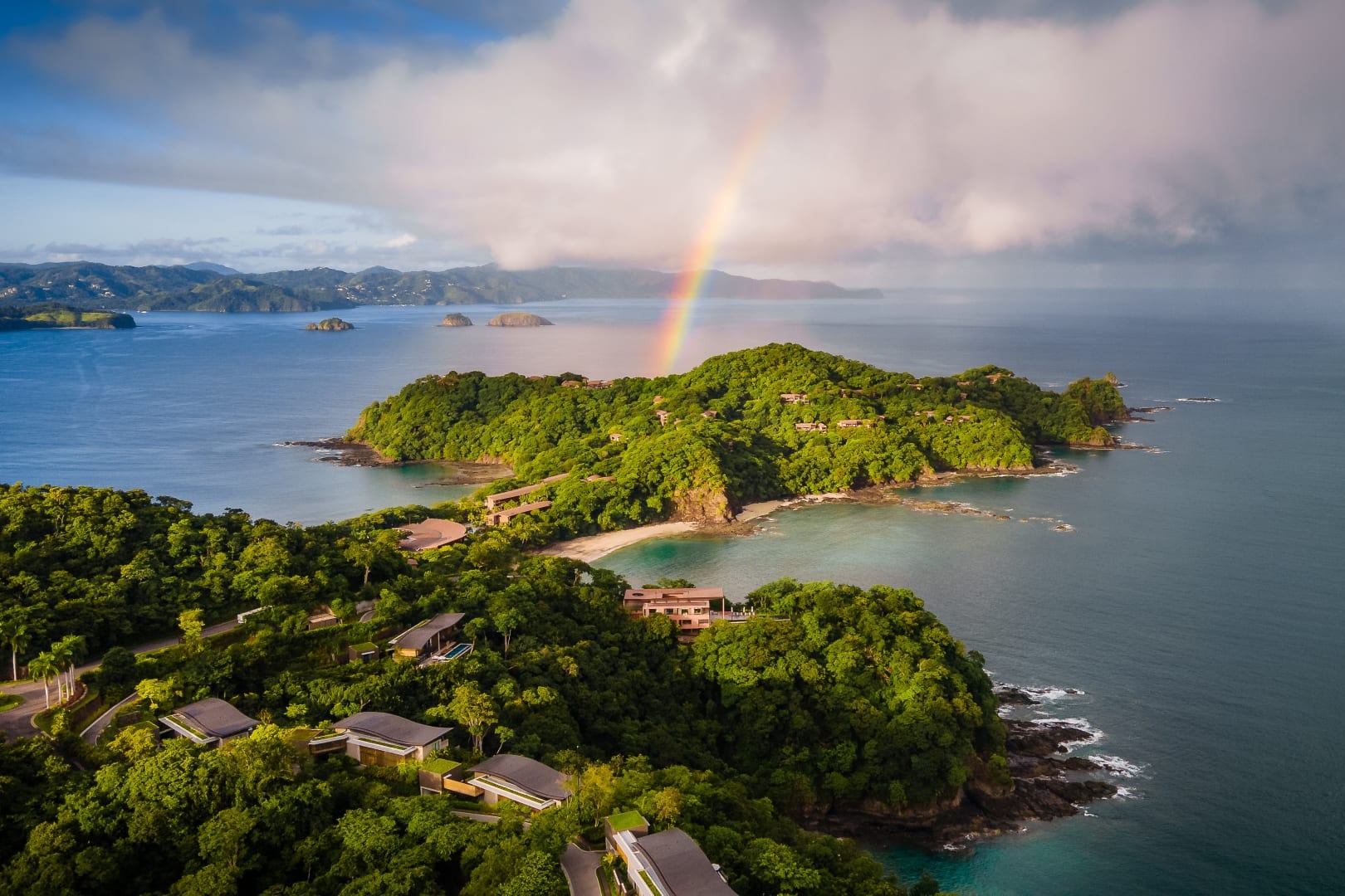 A rainbow drops out of the clouds to touch the very tip of the Papagayo Peninsula