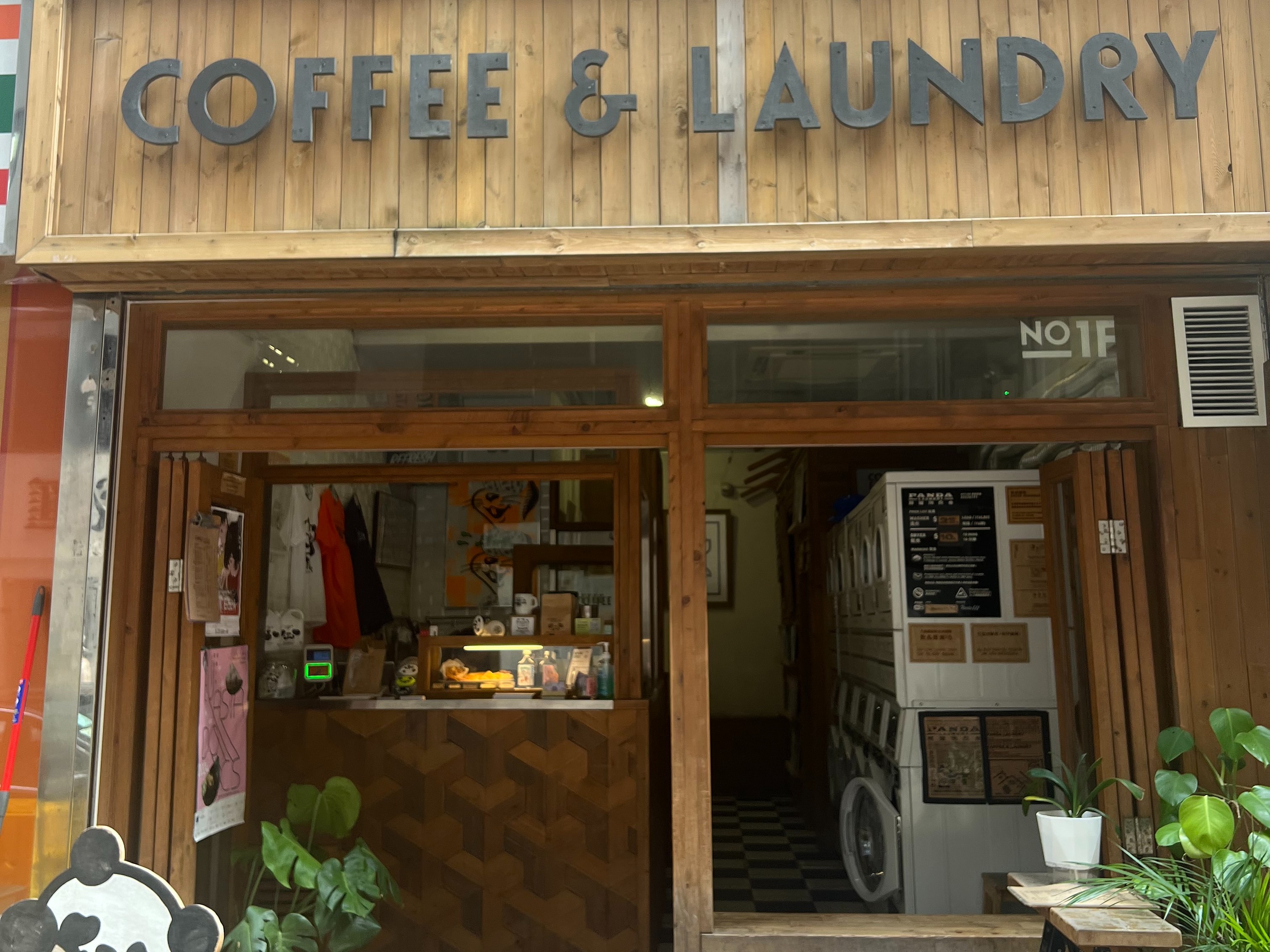 A storefront with a sign that reads “COFFEE & LAUNDRY” which indicates a combined cafe and laundry service.