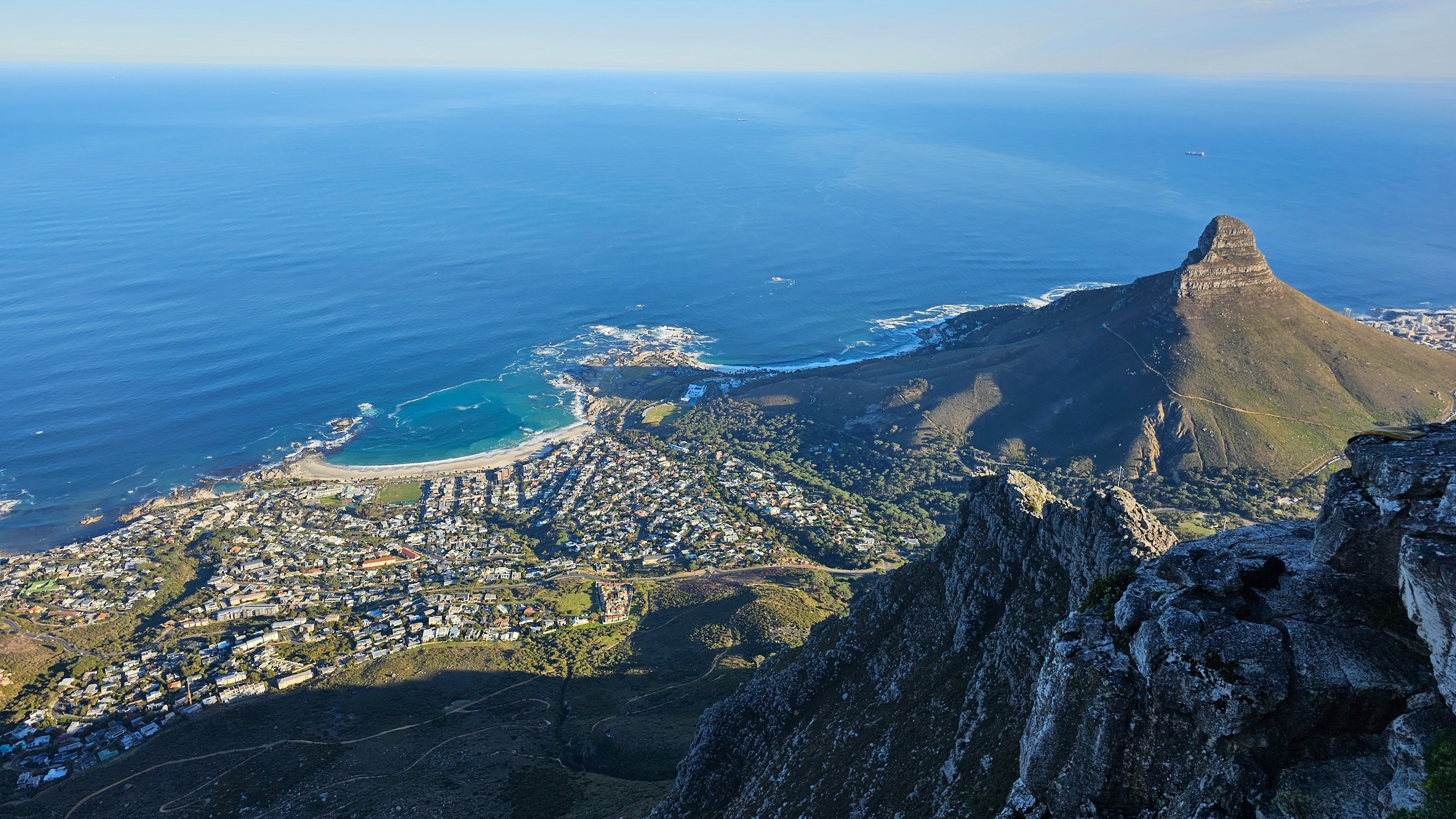A beautiful scenic view of a mountain overlooking the ocean.