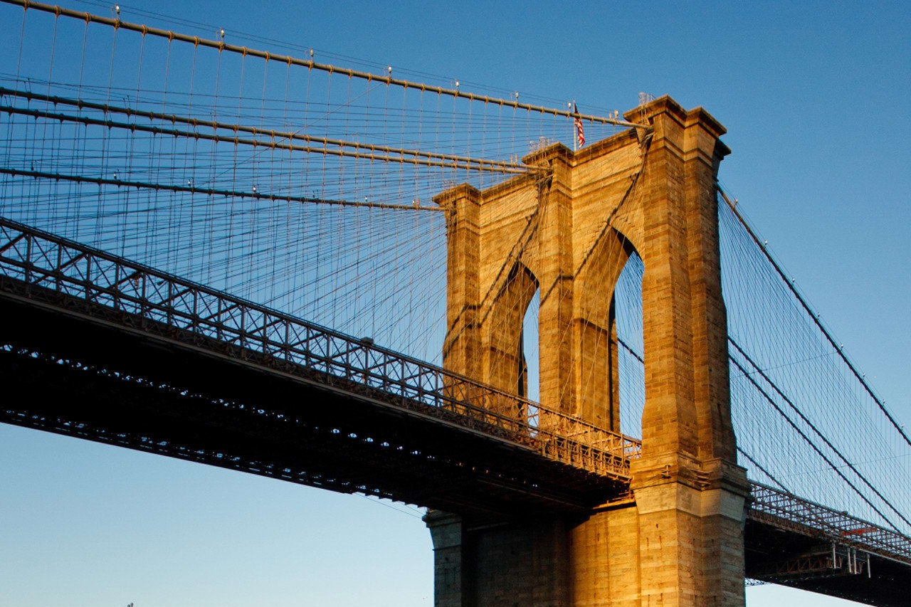 Closeup view of a column belonging to the historic Brooklyn Bridge at twilight