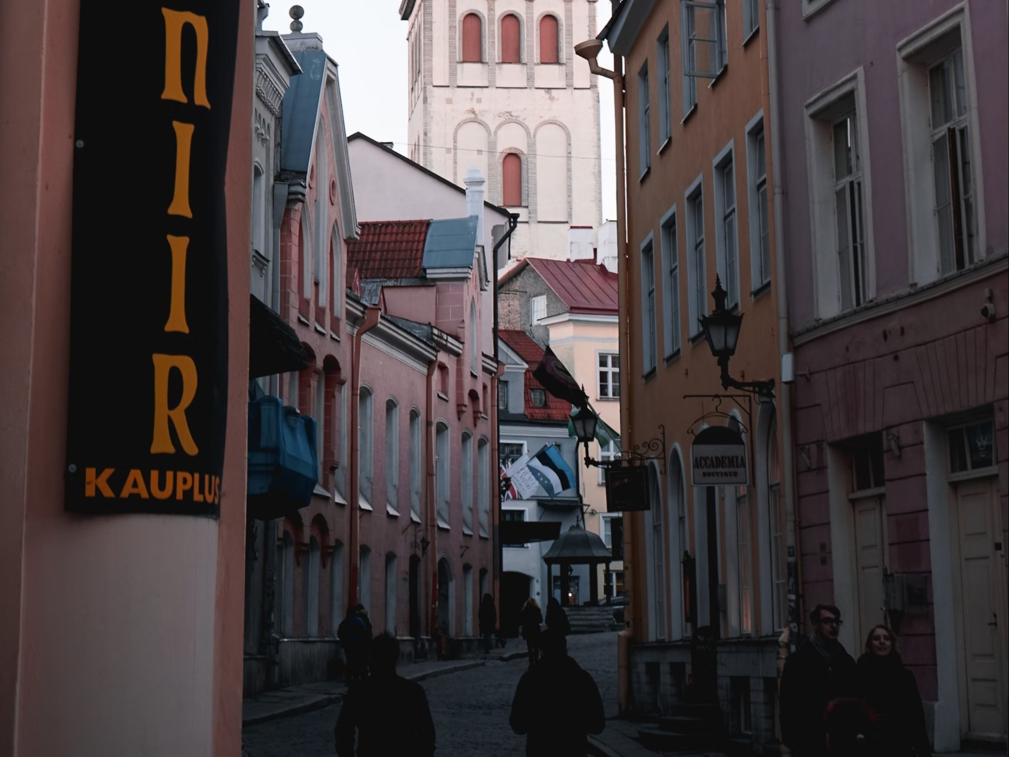 City street with buildings and people walking.