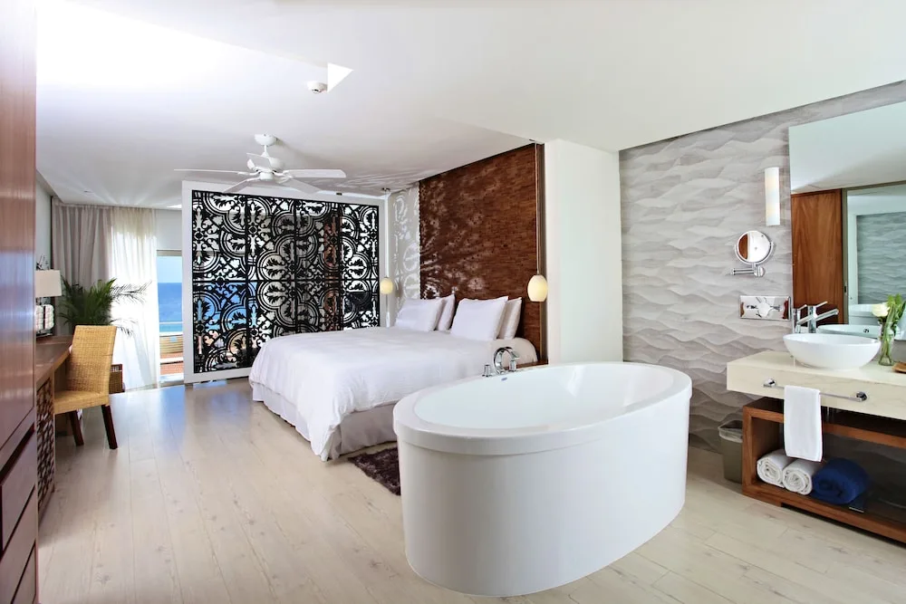 Large room with chic decor, a private ocean-view balcony and deep soaking tub