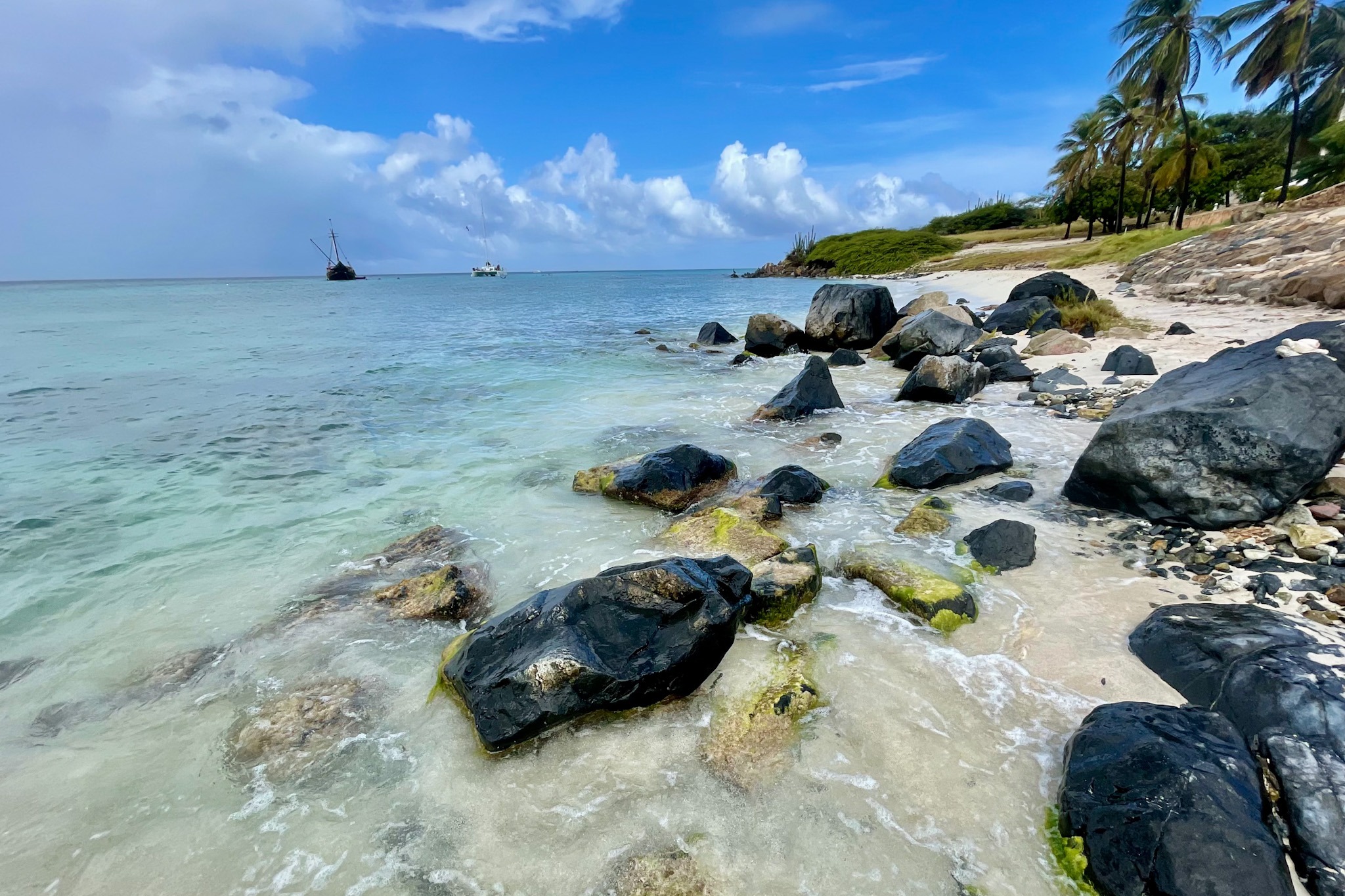 Rocks on a beach shore during the daytime