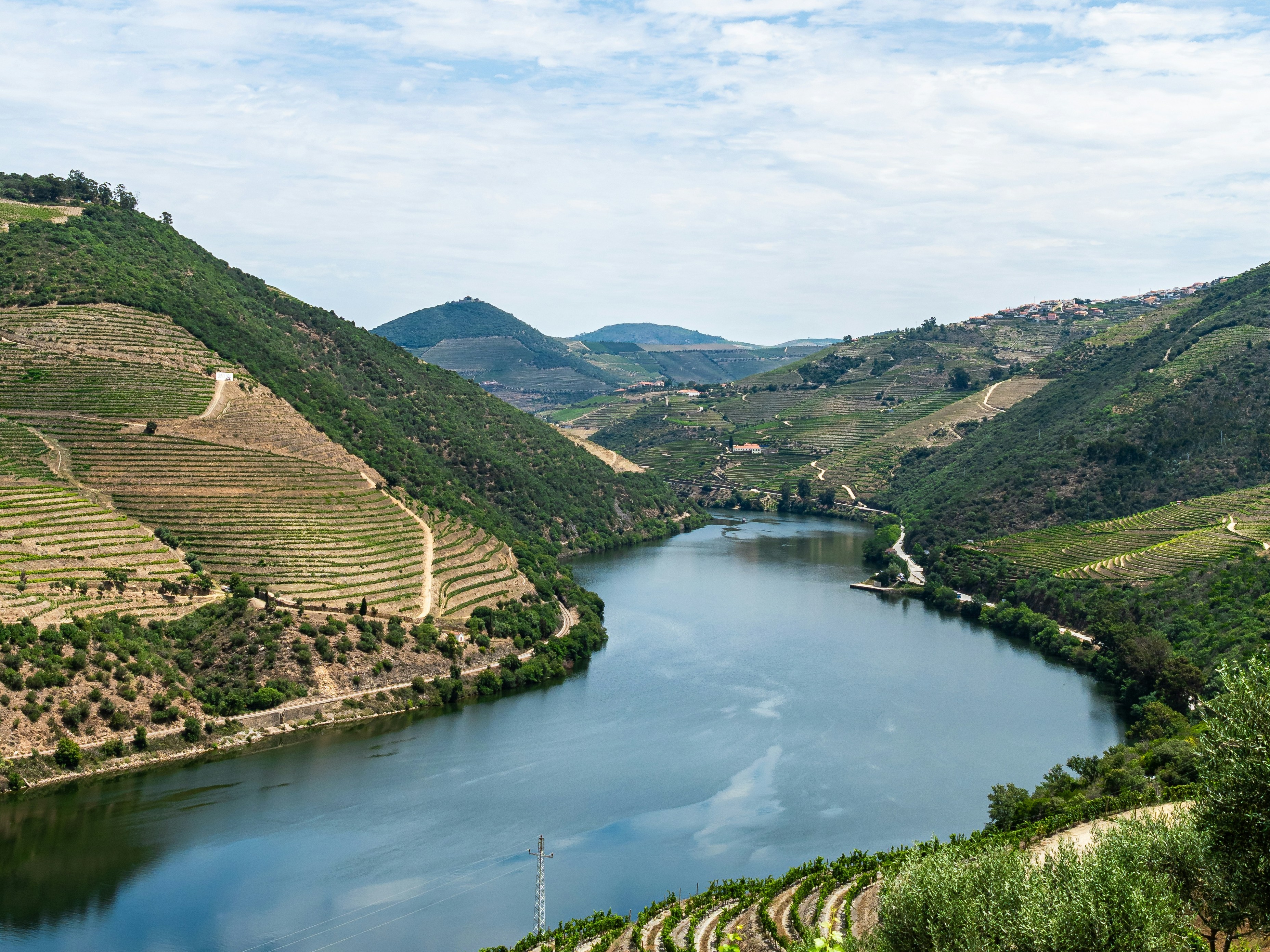 A large body of water between two hills during the daytime