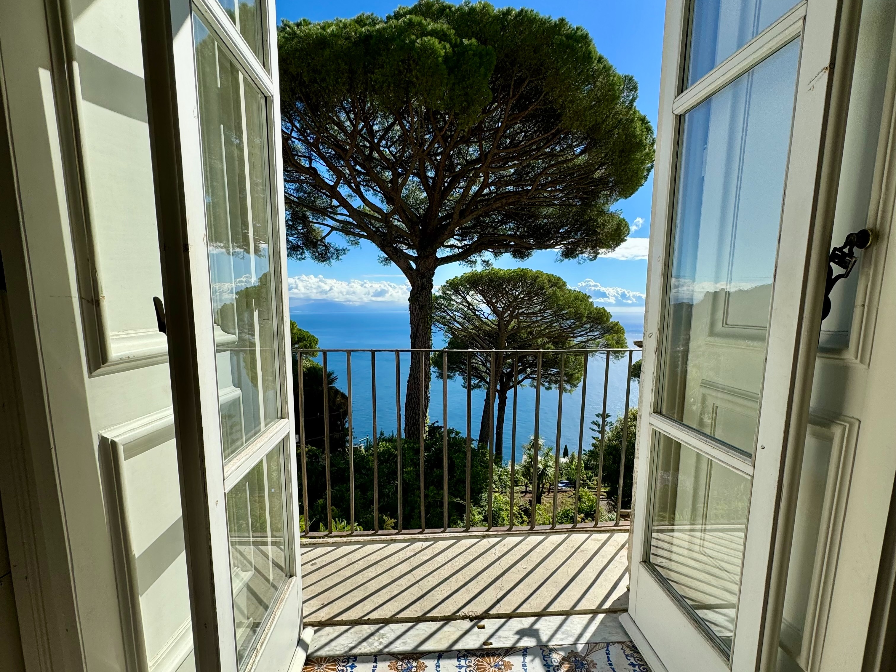 A statue on a terrace with a view of the sea
