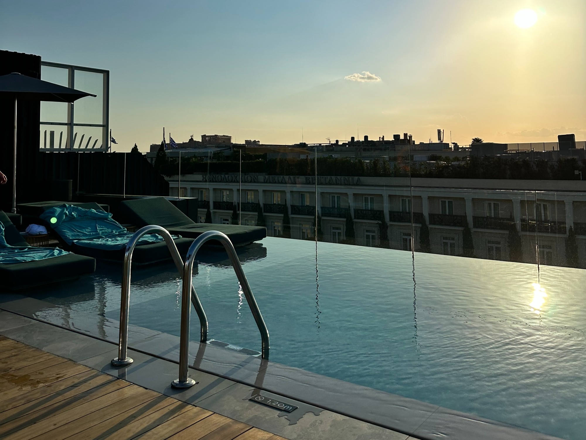 Rooftop pool with lounging chairs.