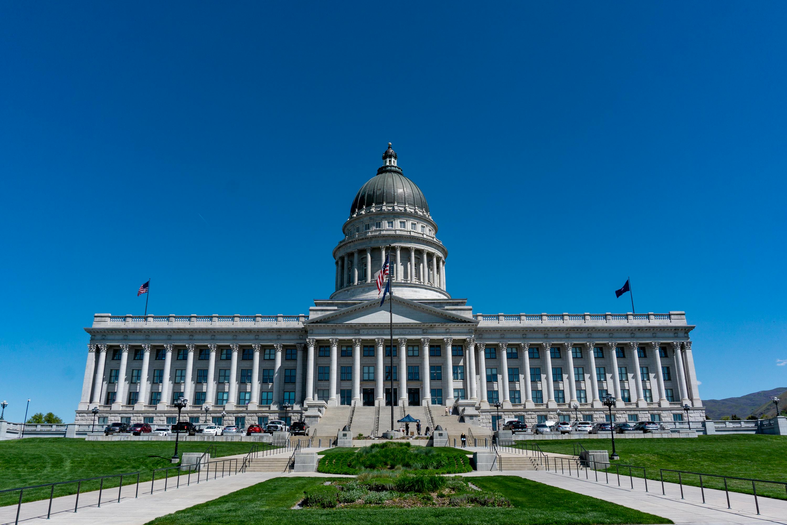 A capitol building under a blue sky