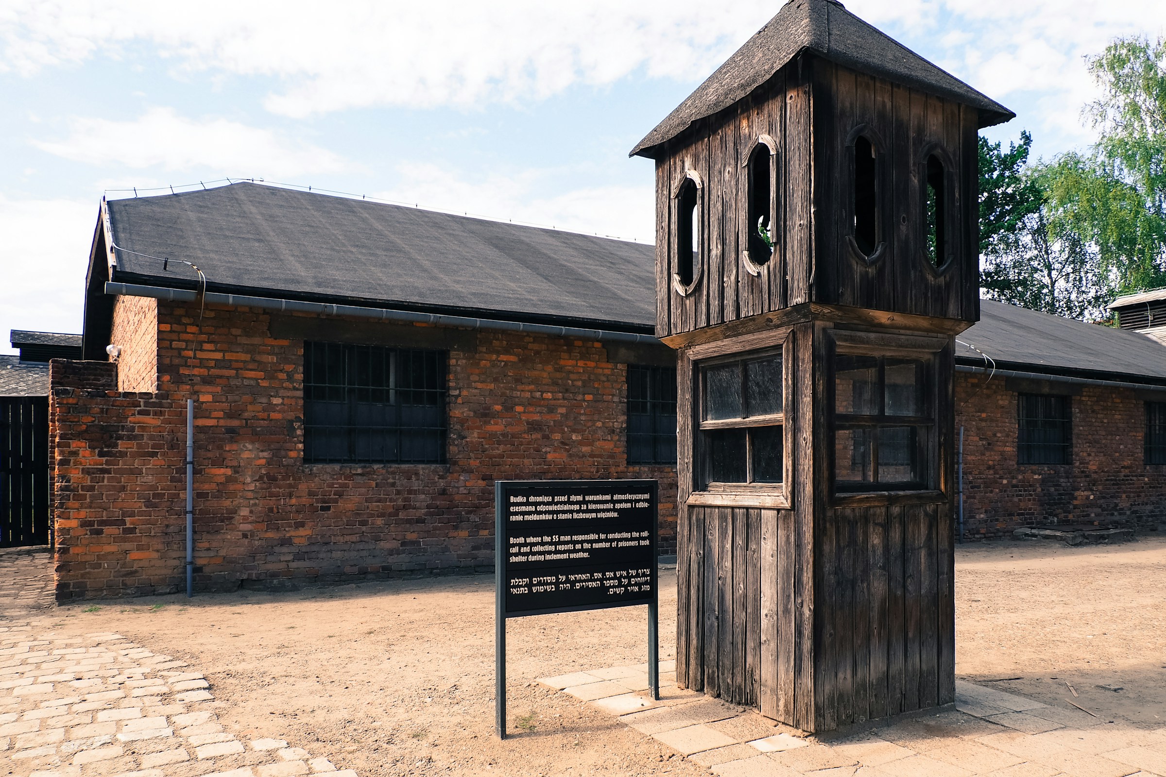 A tall wooden clock tower at Auschwitz concentration camp.