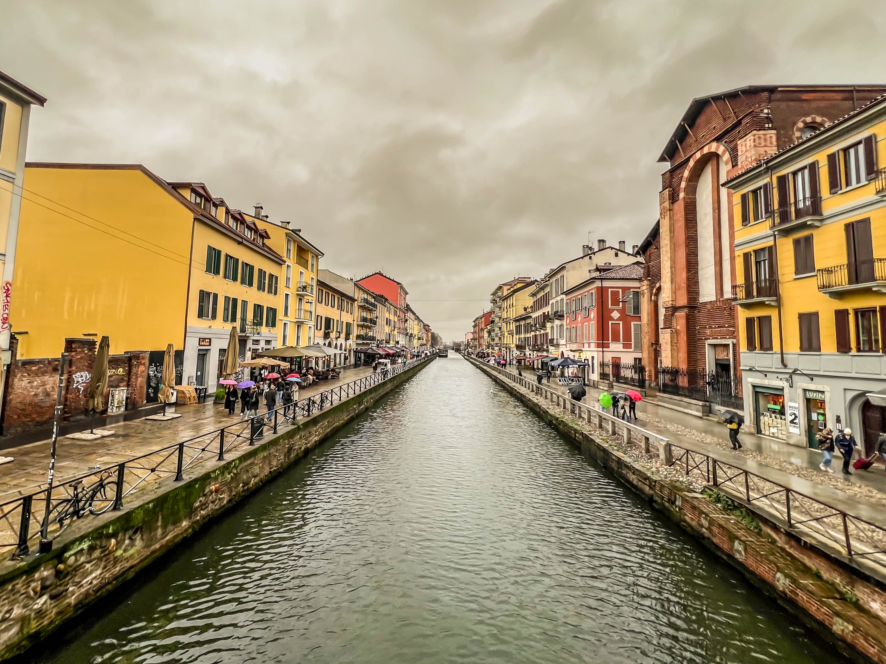 A water canal lined with colorful buildings under an overcast sky.