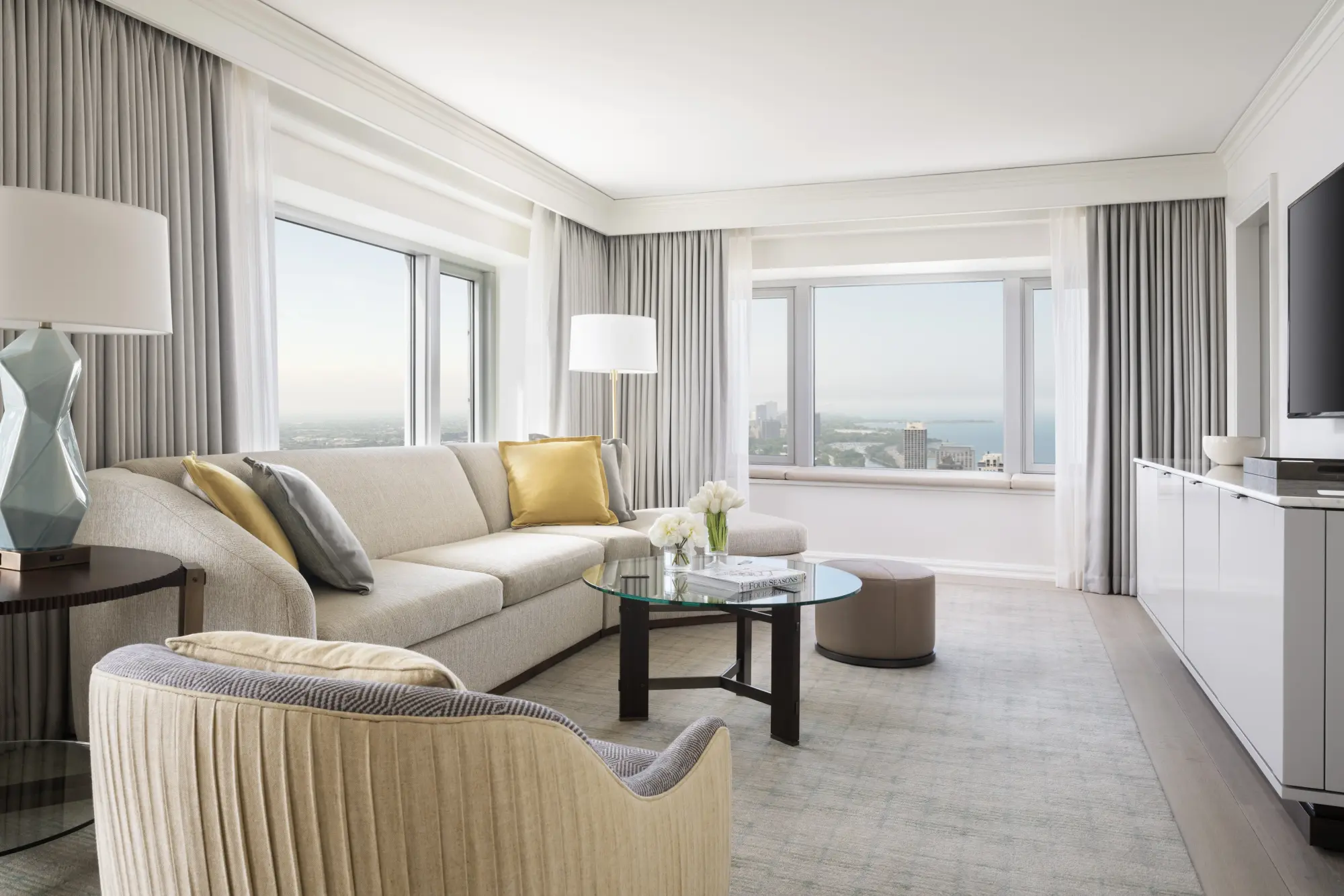 Spacious living room with chic decor and a great view of Chicago's skyline and Lake Michigan