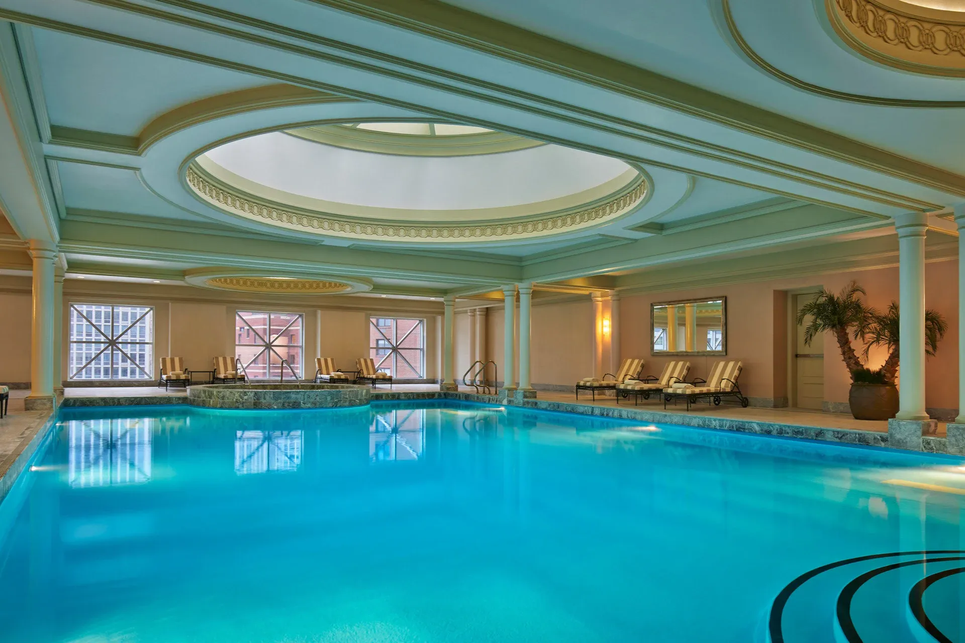 Elegant architecture surrounds a massive indoor pool