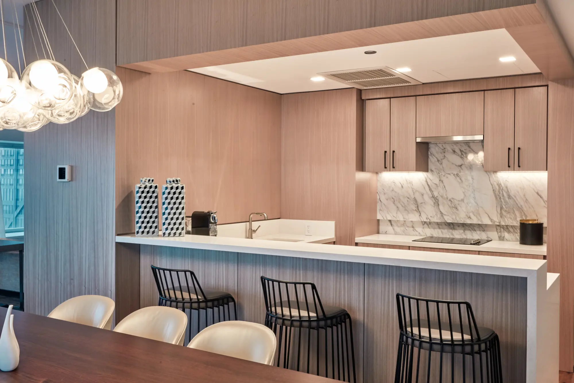 A bar lined with three chic stools