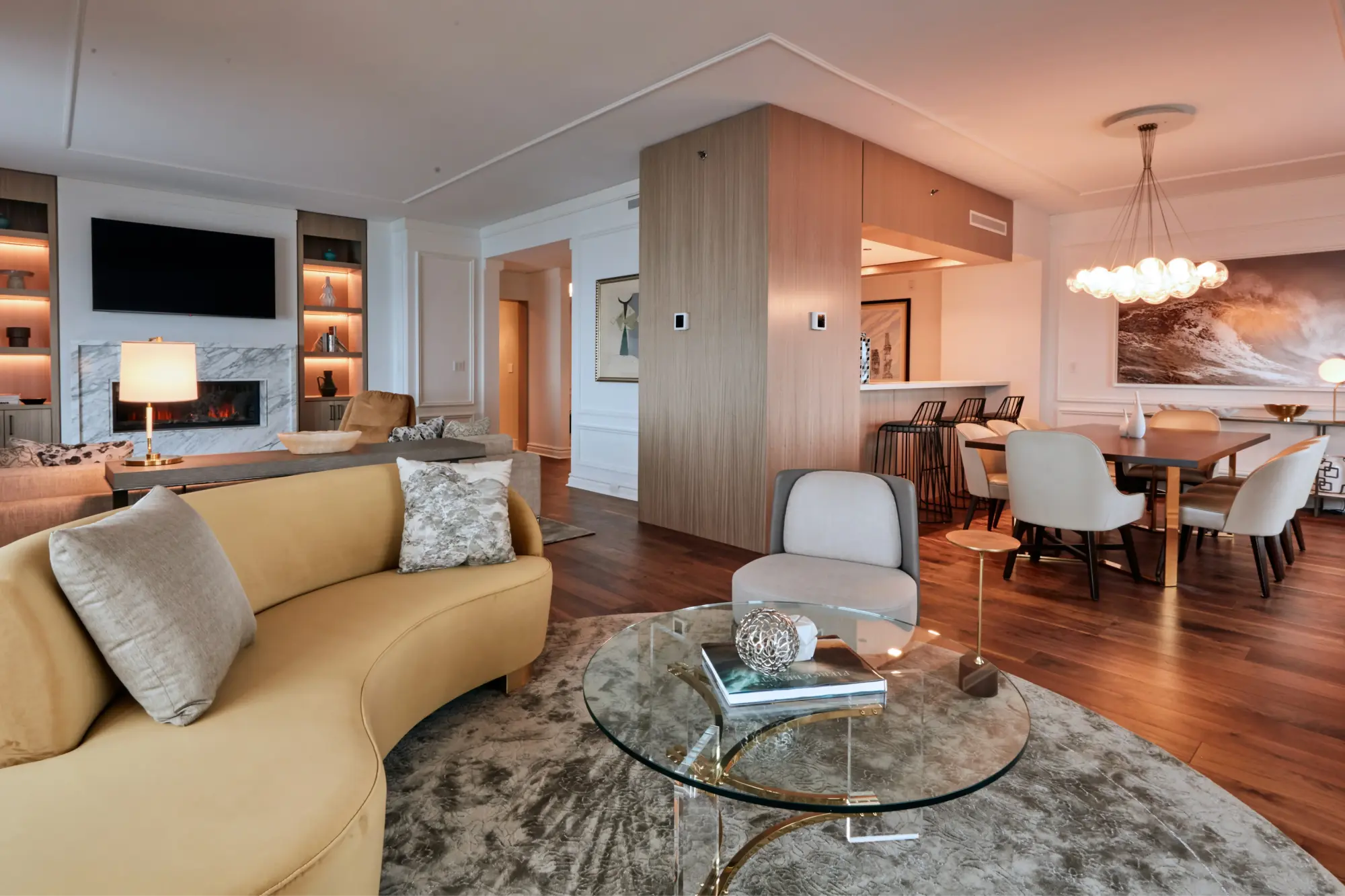 Spacious suite with separate dining, living and sleeping areas filled with classy decor and high-end details like hardwood floors, glass tables and a large flatscreen