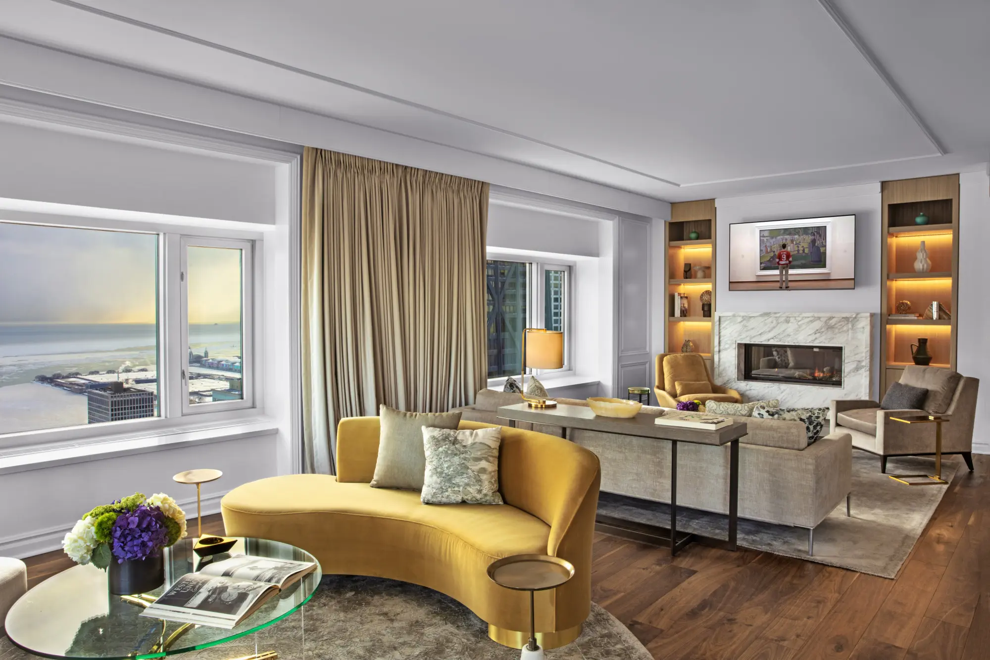 Gold-trim furniture and decor set the tone in this expansive suite living area with views of Lake Michigan