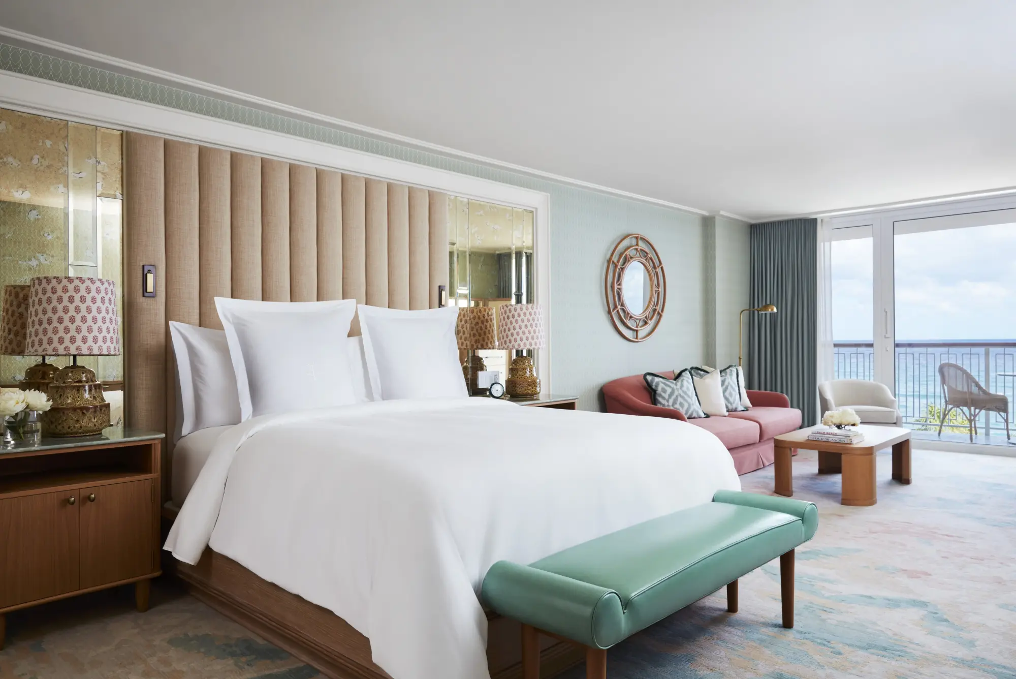 Expansive guest room with a private balcony, comfy furnishings and an elegant, but coastal-theme