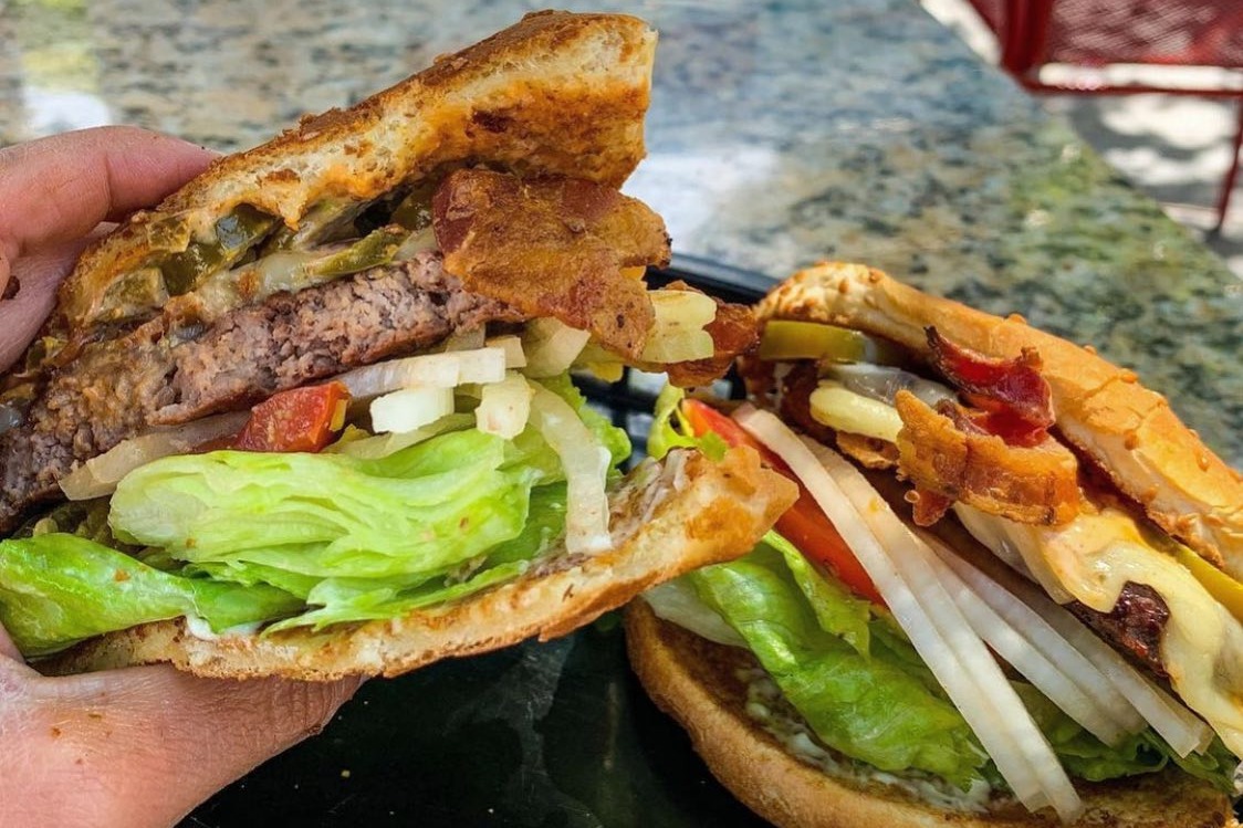 A sandwich full of meat and vegetables