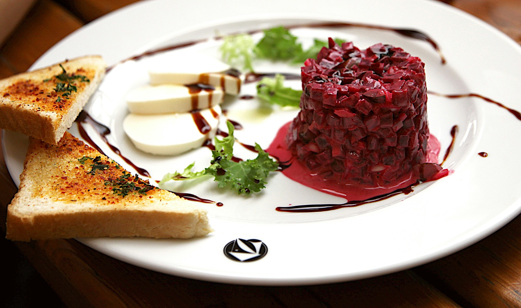 Fine dining food plated carefully on a white dish.