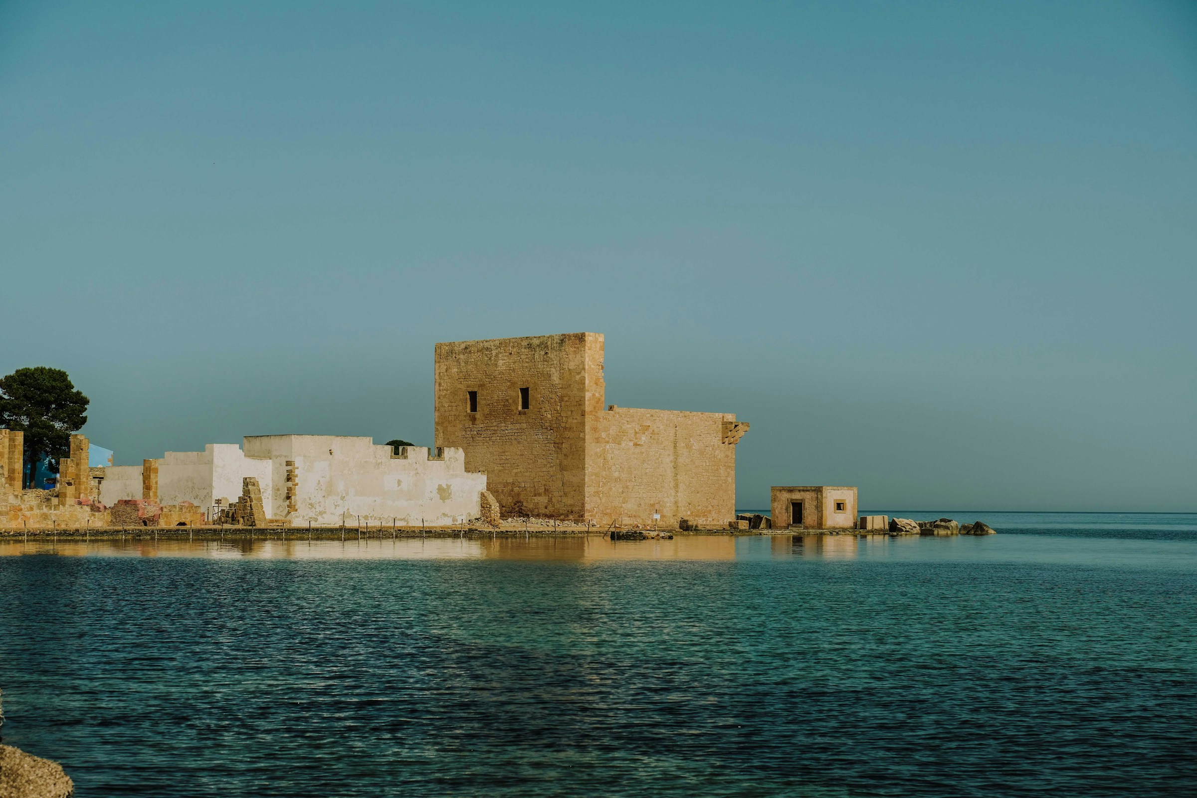 A stone building and ruins dating back several centuries at Tonnara di Vendicari, Noto.