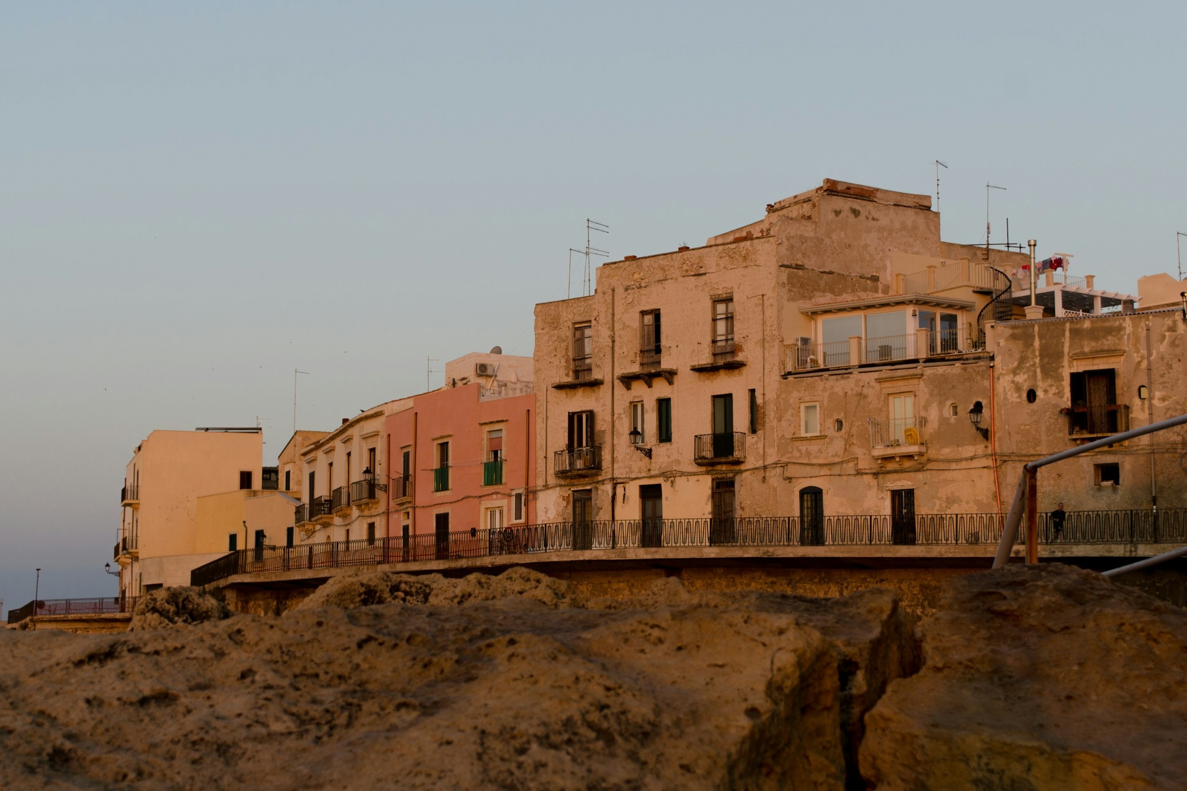 Brown concrete building arranged along a coast.