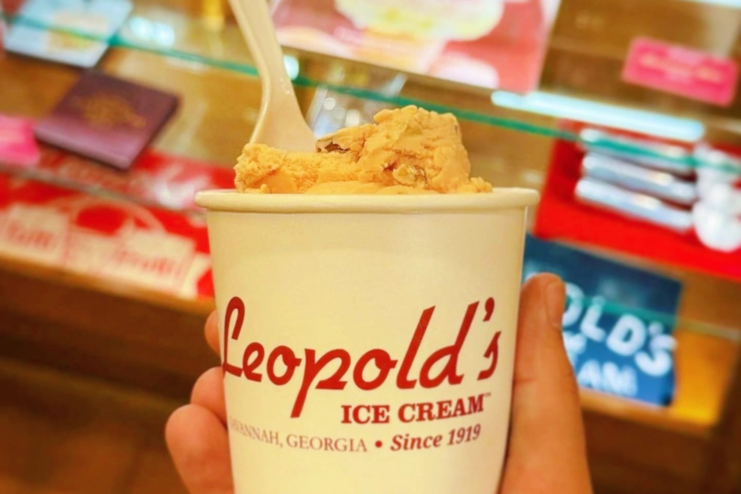 A paper cup reading "Leopold's Ice Cream" with tan-colored ice cream.