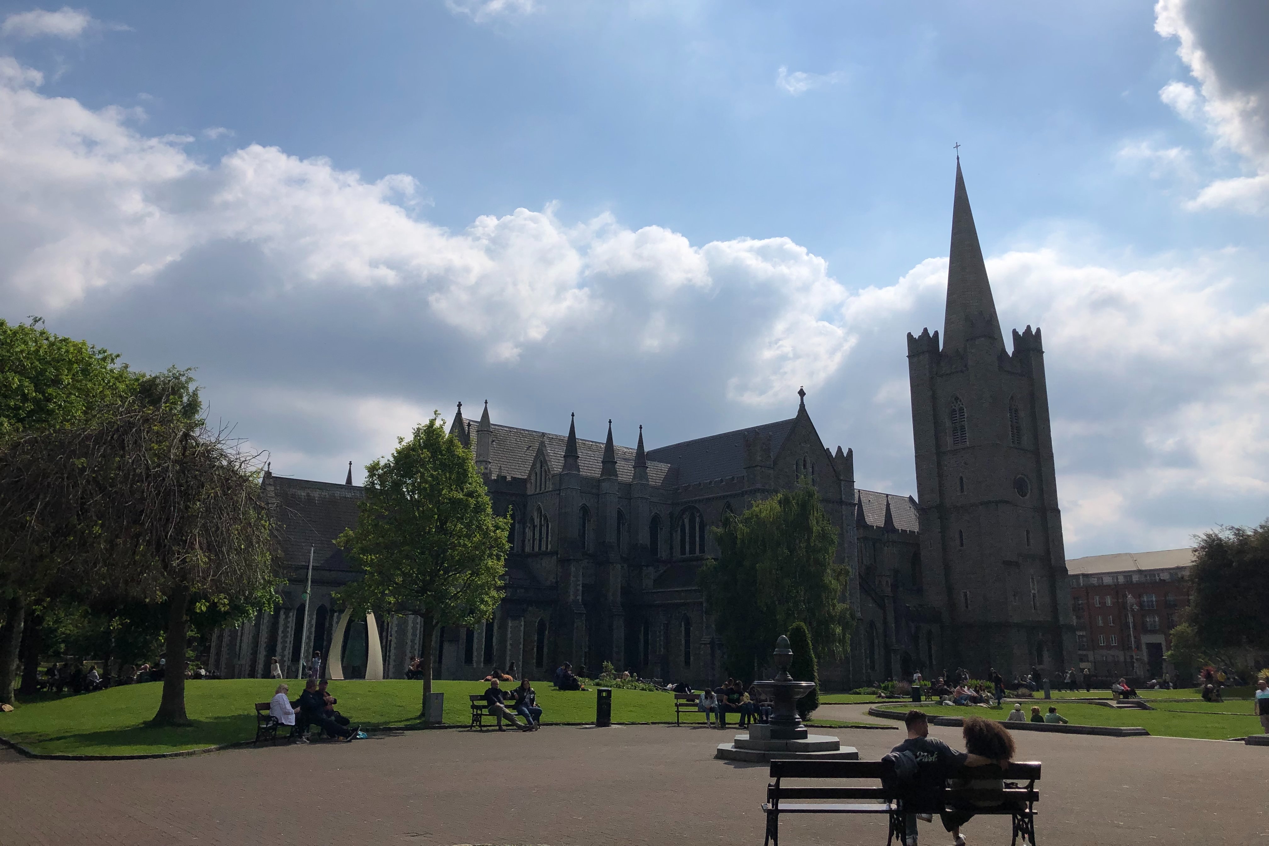A park outside of a cathedral building during the daytime