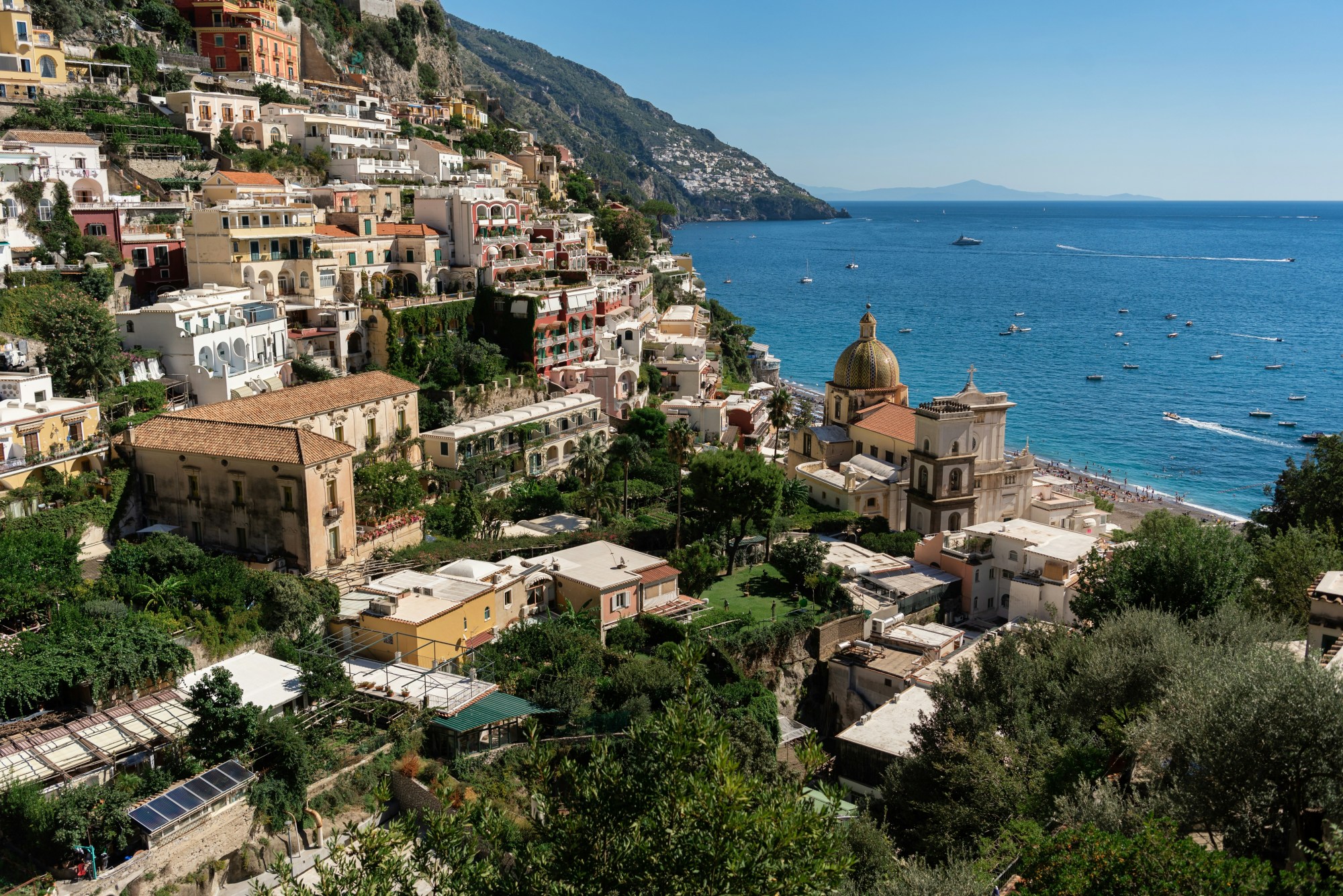 View of a hillside town next to a body of water during the daytime