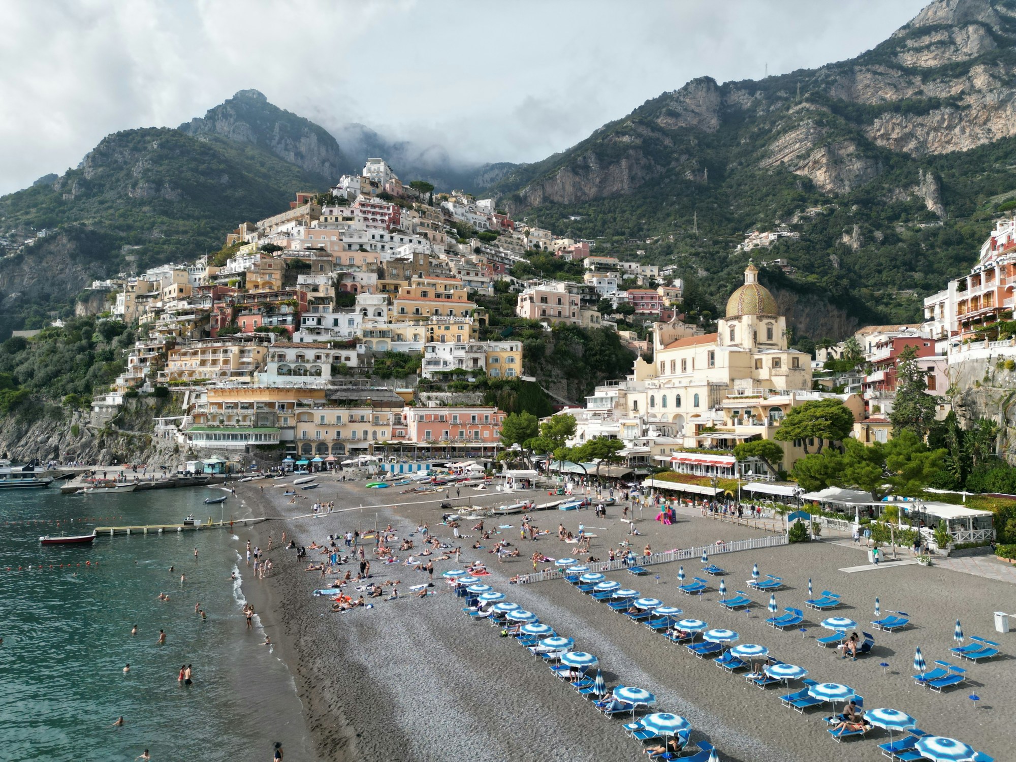 People on beach with umbrellas.