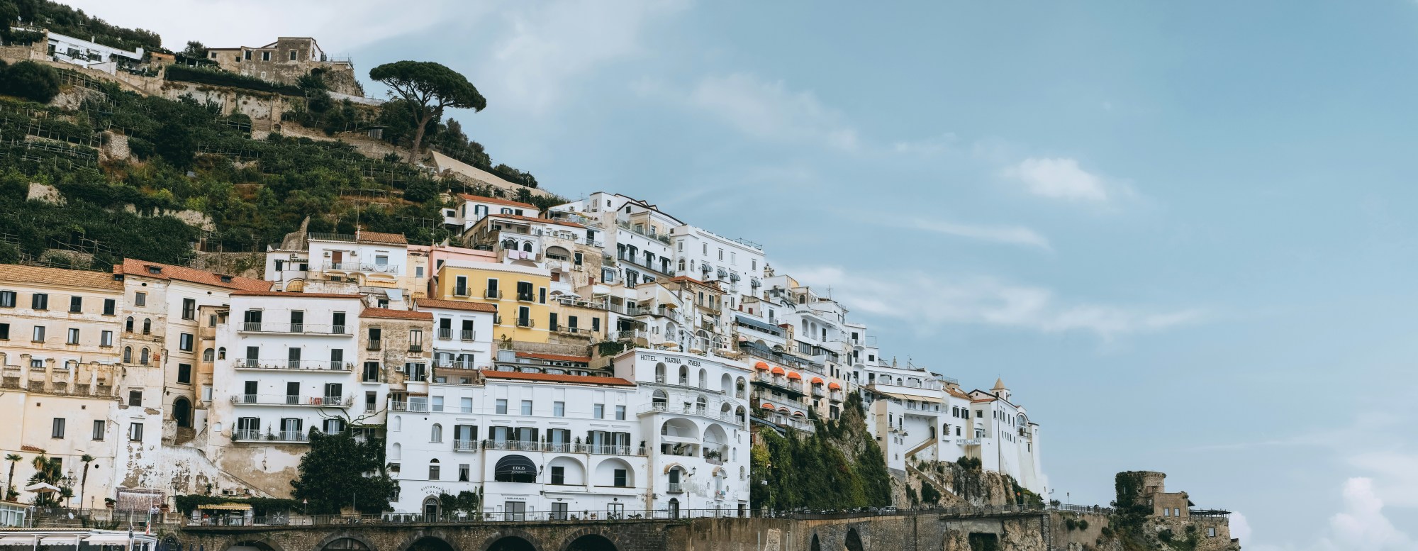 White buildings on a hill side during the daytime