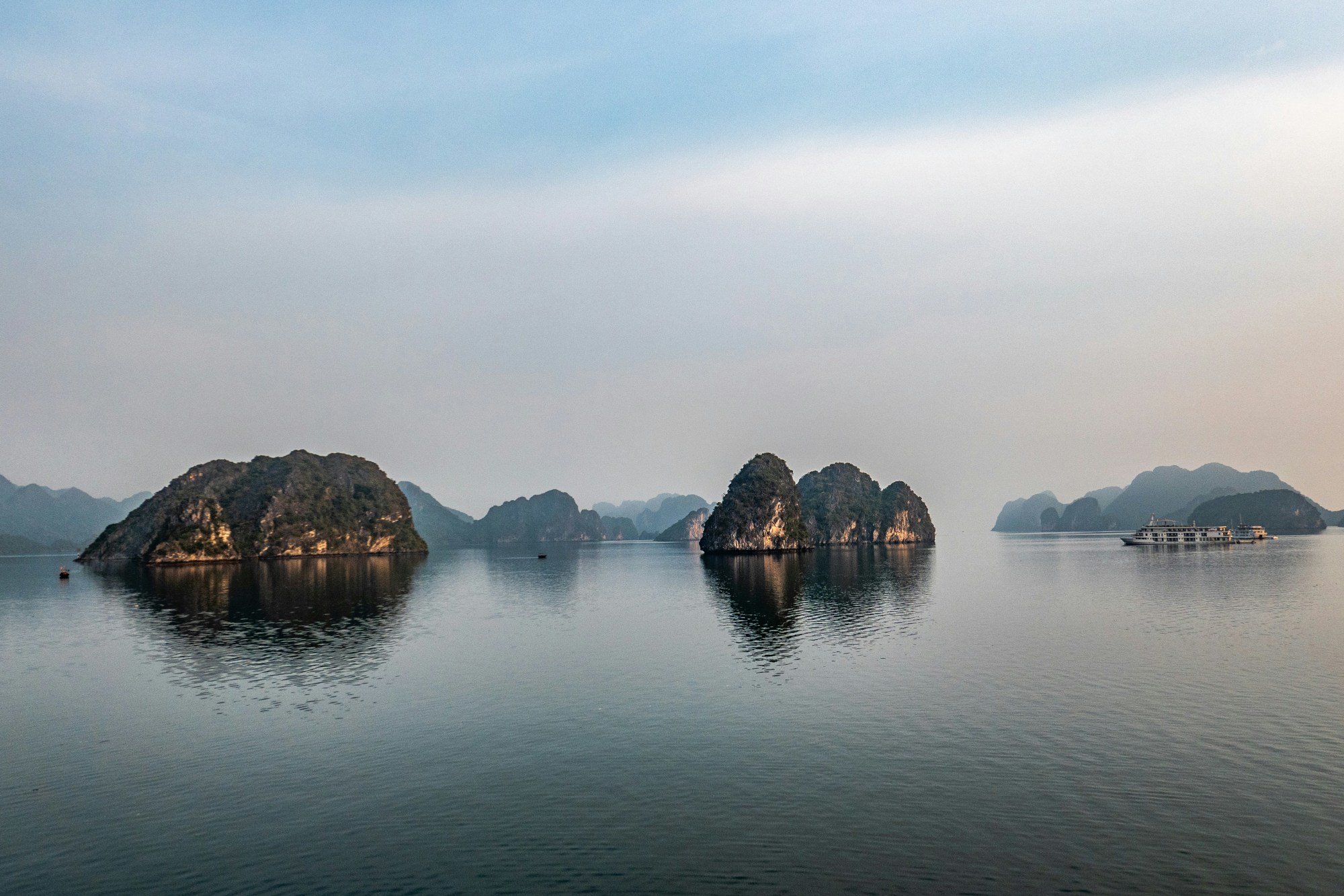 Rock formations in a body of water during a foggy day