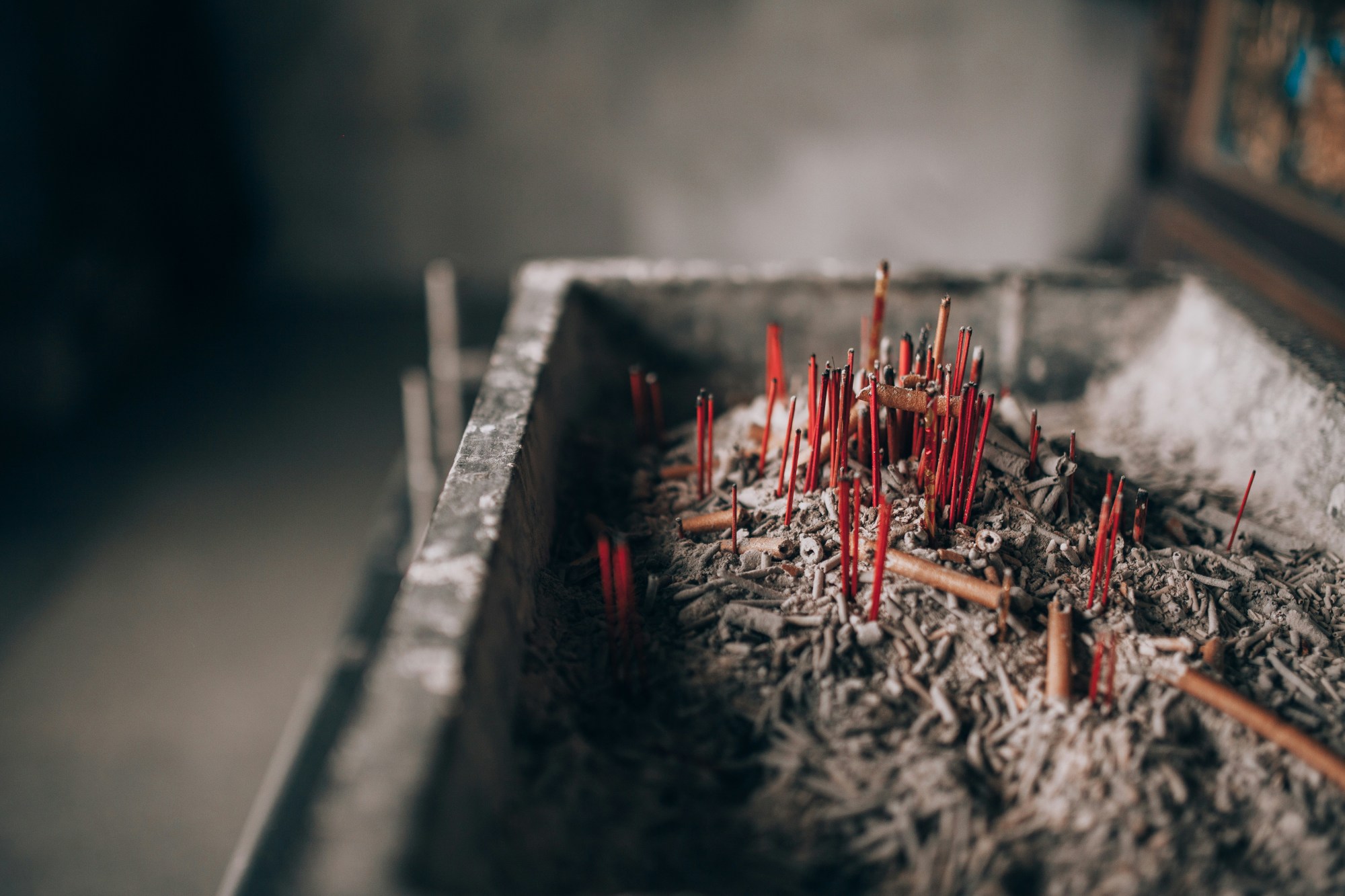 Red wires among ashes in a dimly lit room