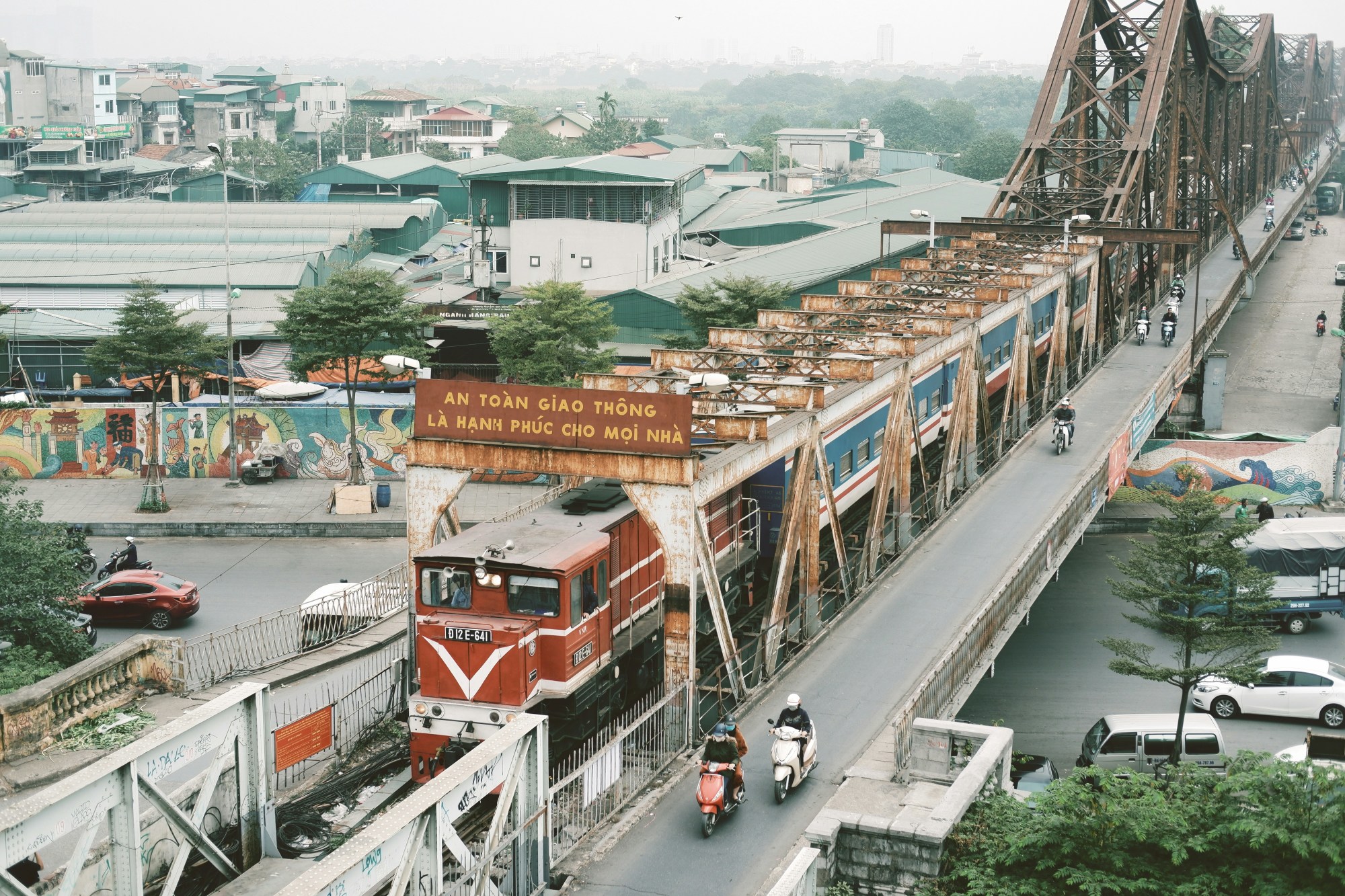 Aerial view of a bridge with a train running through the center of it