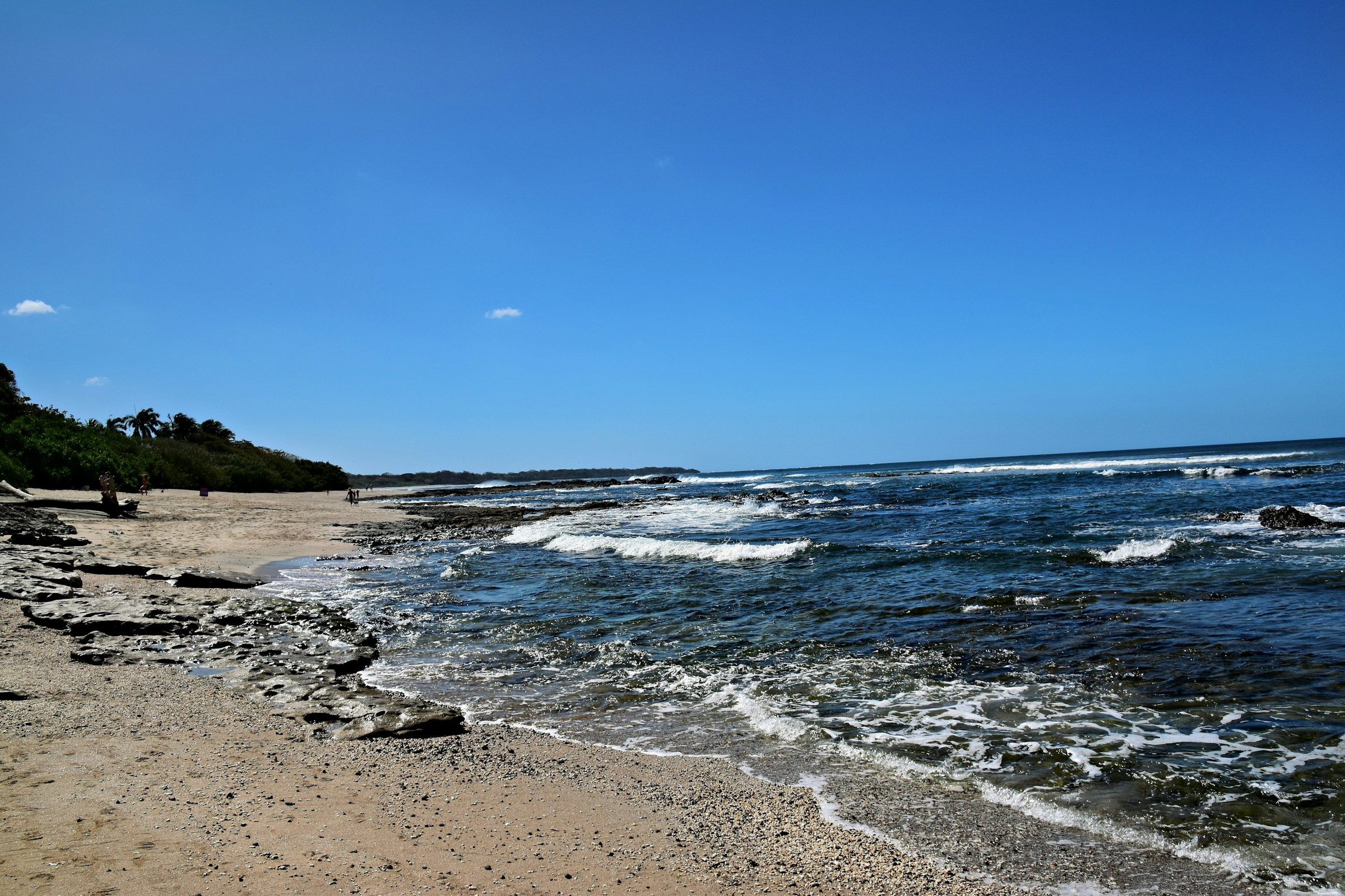 Waves approaching the shore on a beach during the daytime
