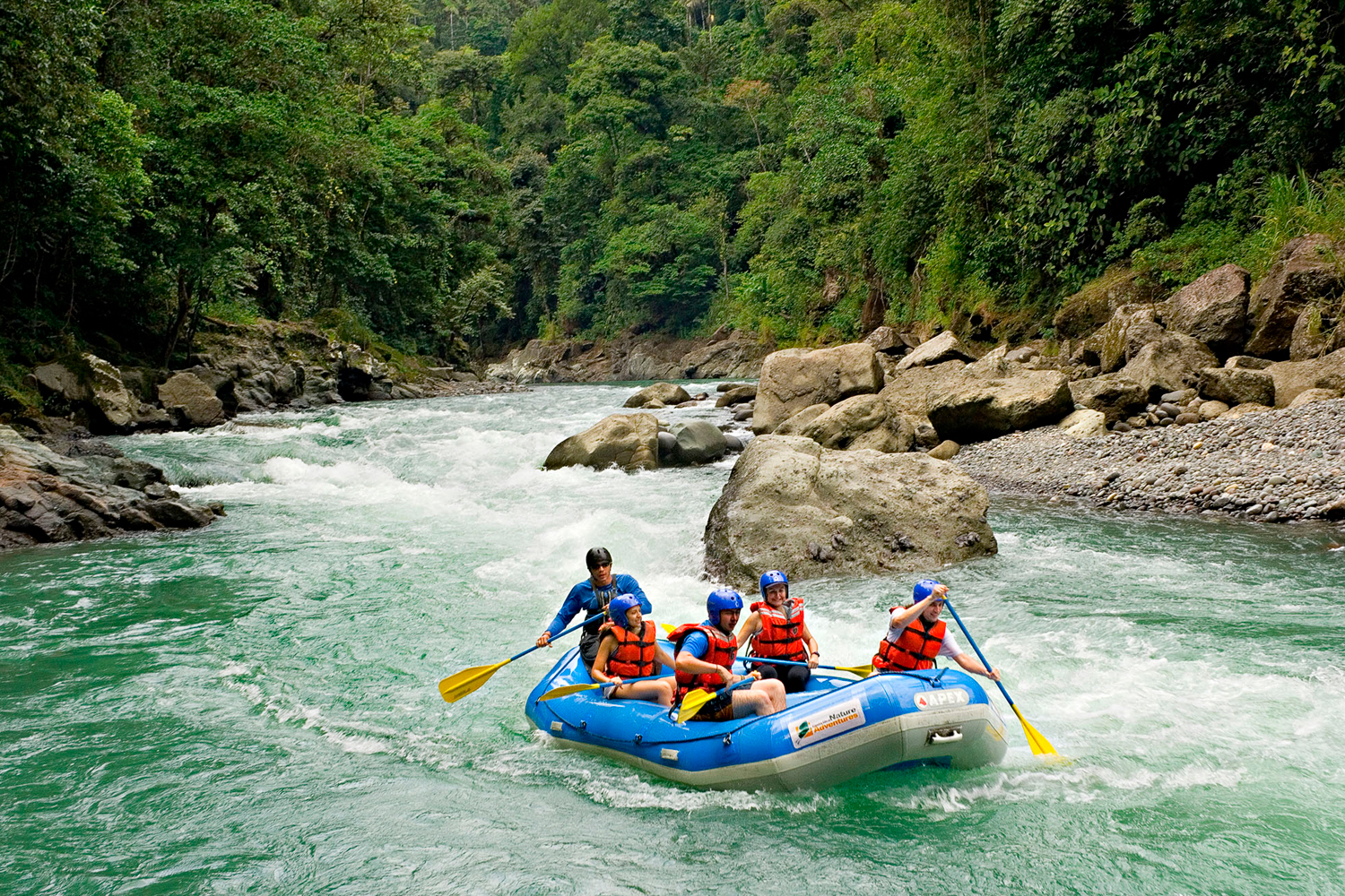 People rafting on river.