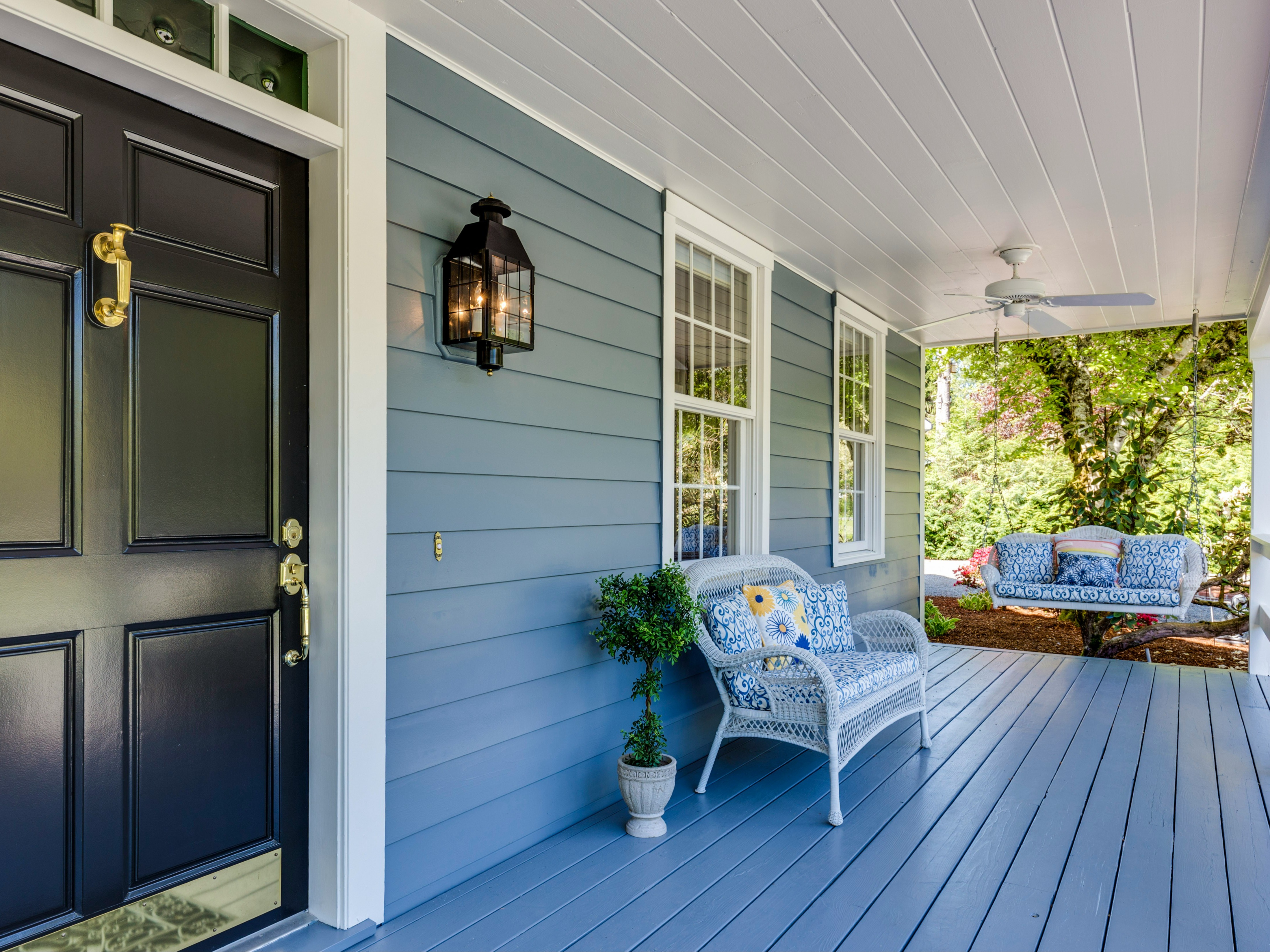 A well-lit front porch with cozy seating and charming decor welcomes you home.