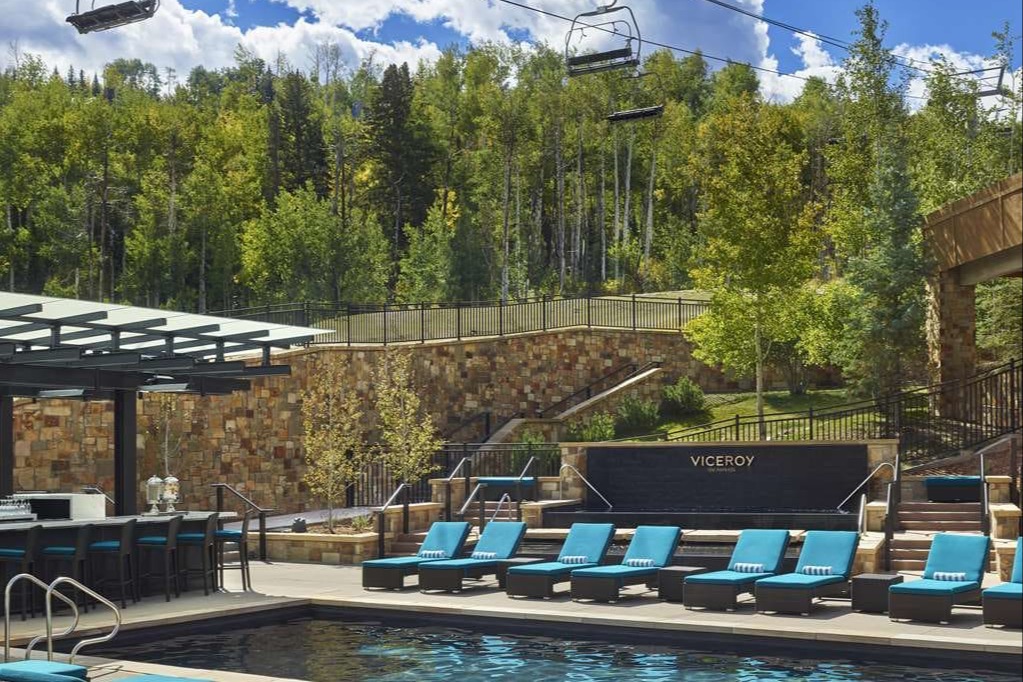 Ski lift cars descend over Viceroy Snowmass' chic pool area
