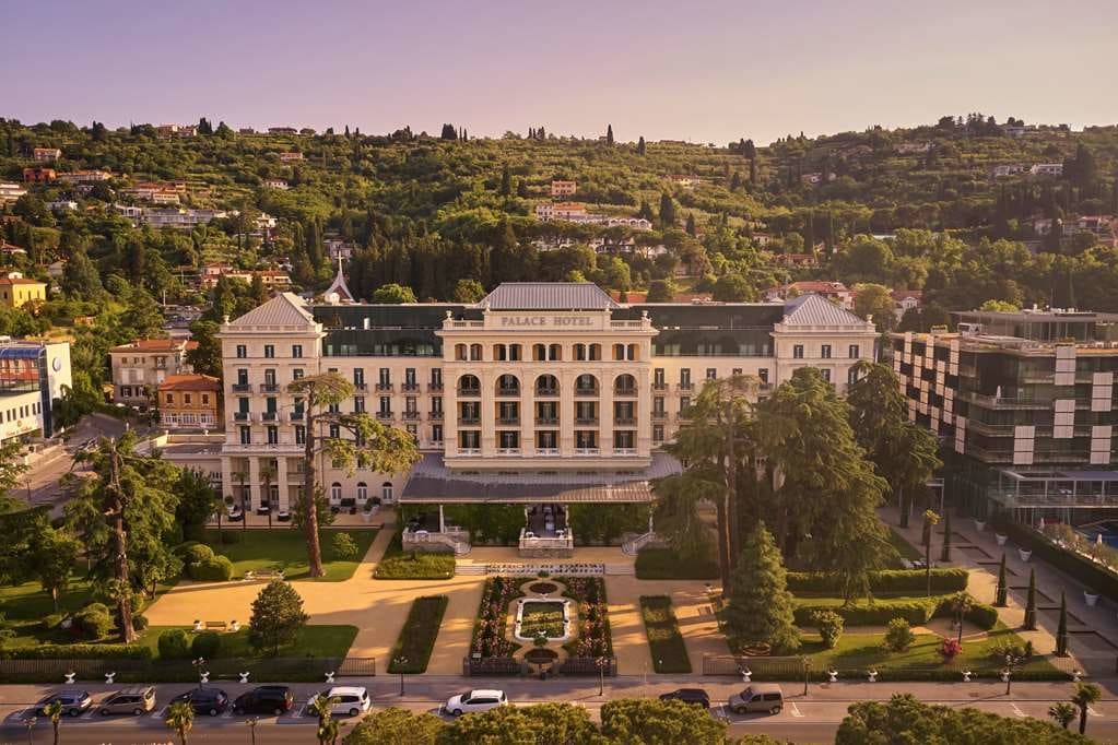 aerial view of a palace hotel amid lush green hills