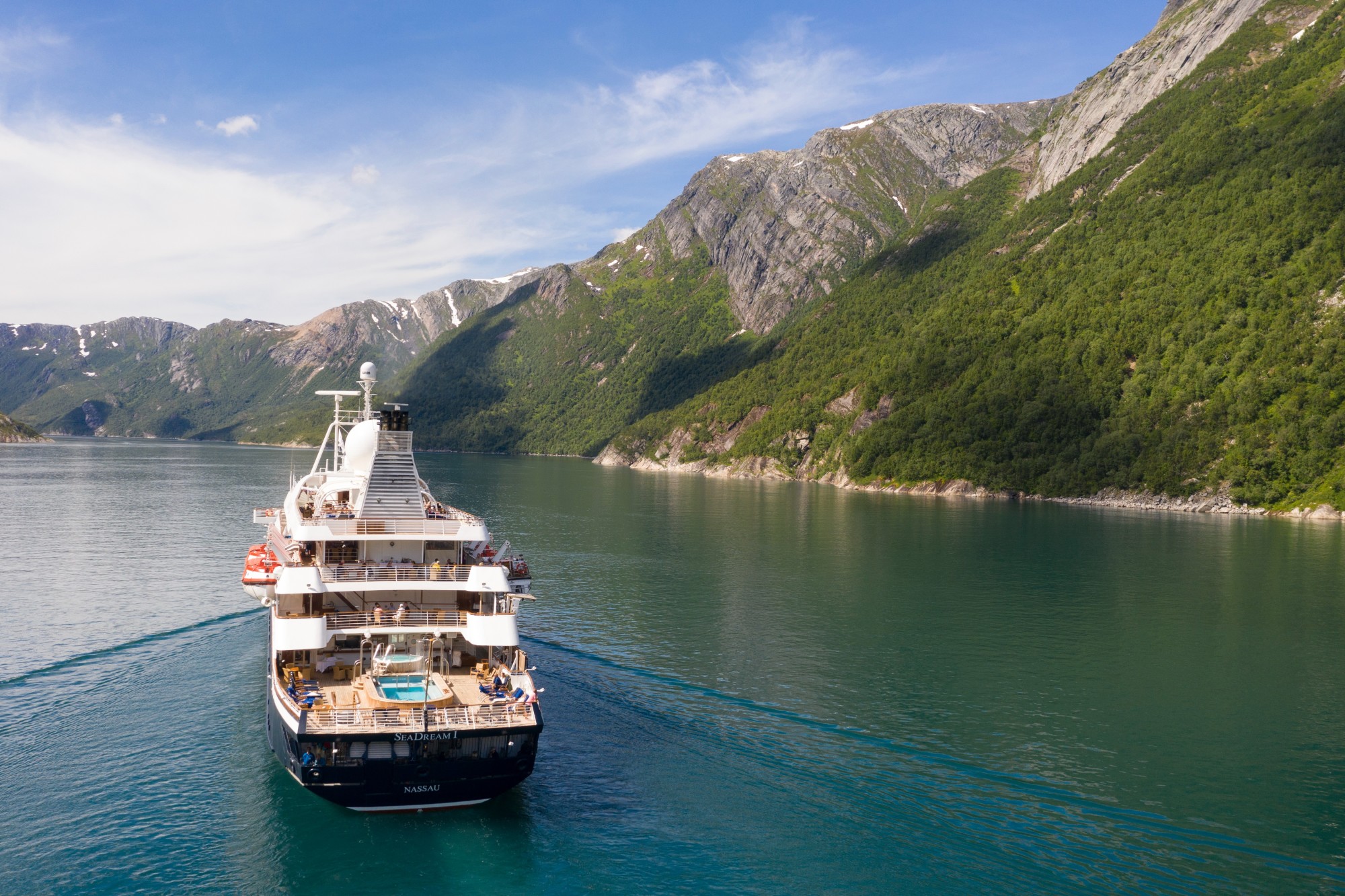 a luxury yacht on a Norwegian fjord on a sunny day