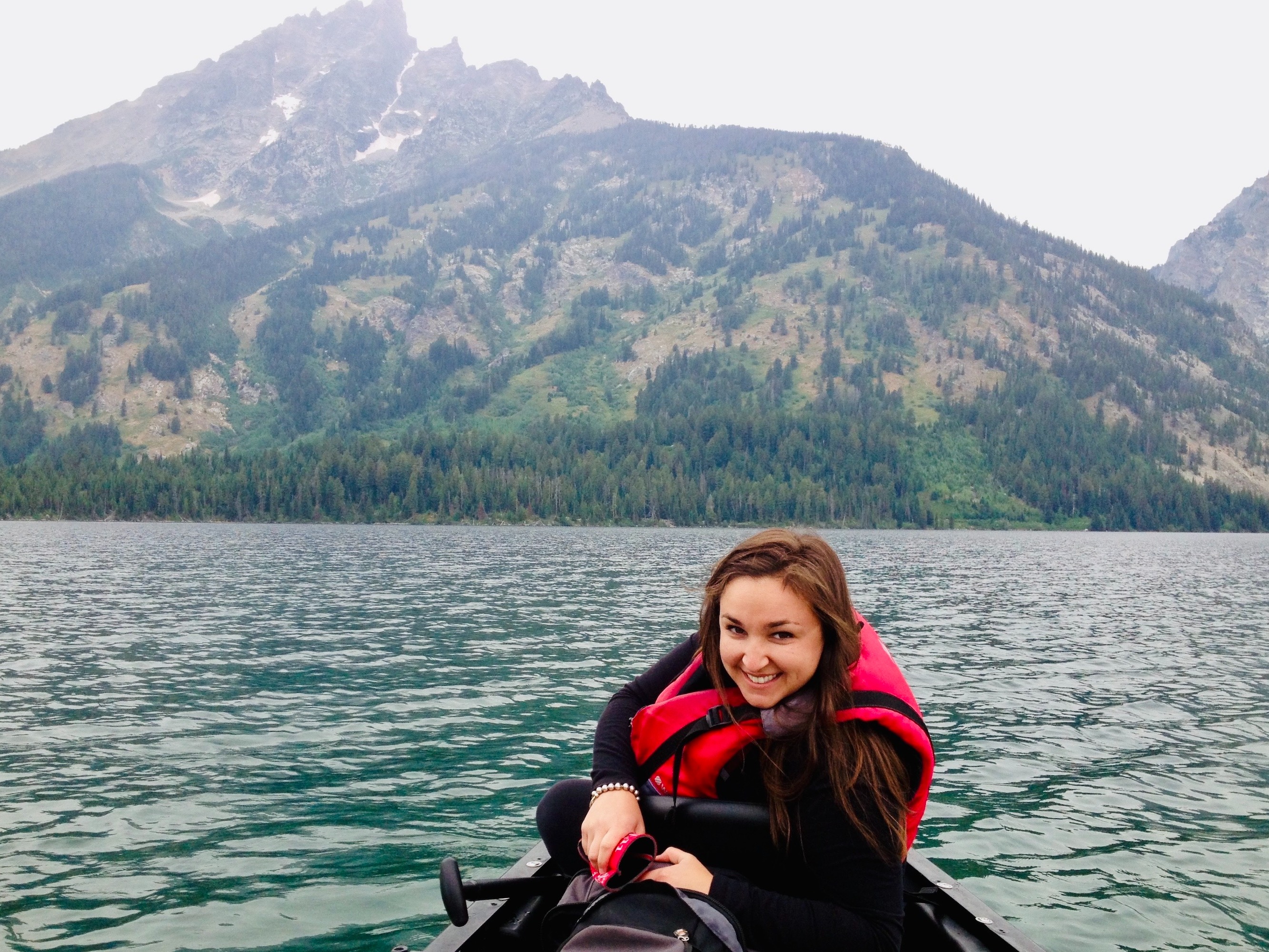 A serene boat ride with majestic mountains in the background.