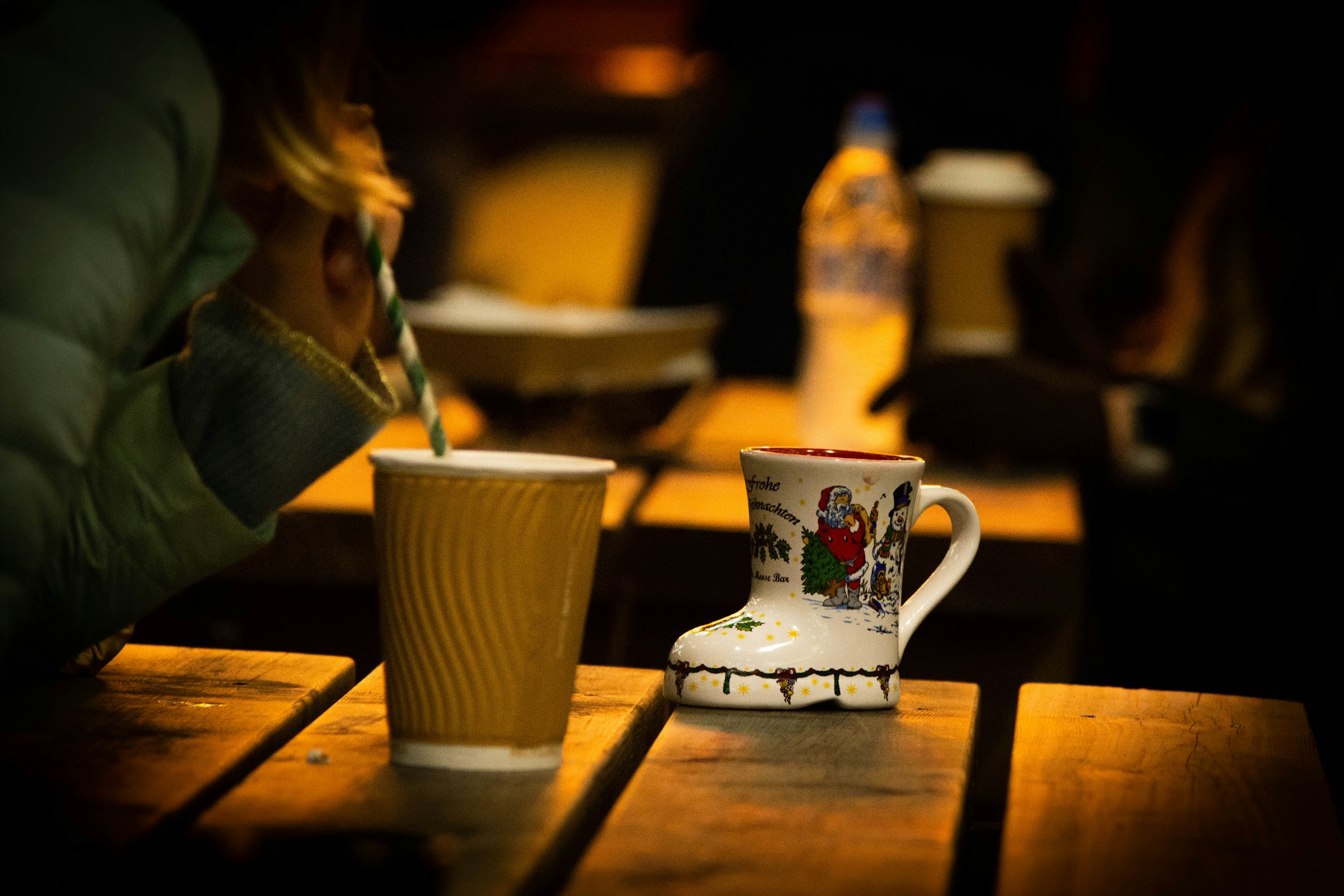 A cup of coffee on a table in a dimly lit room