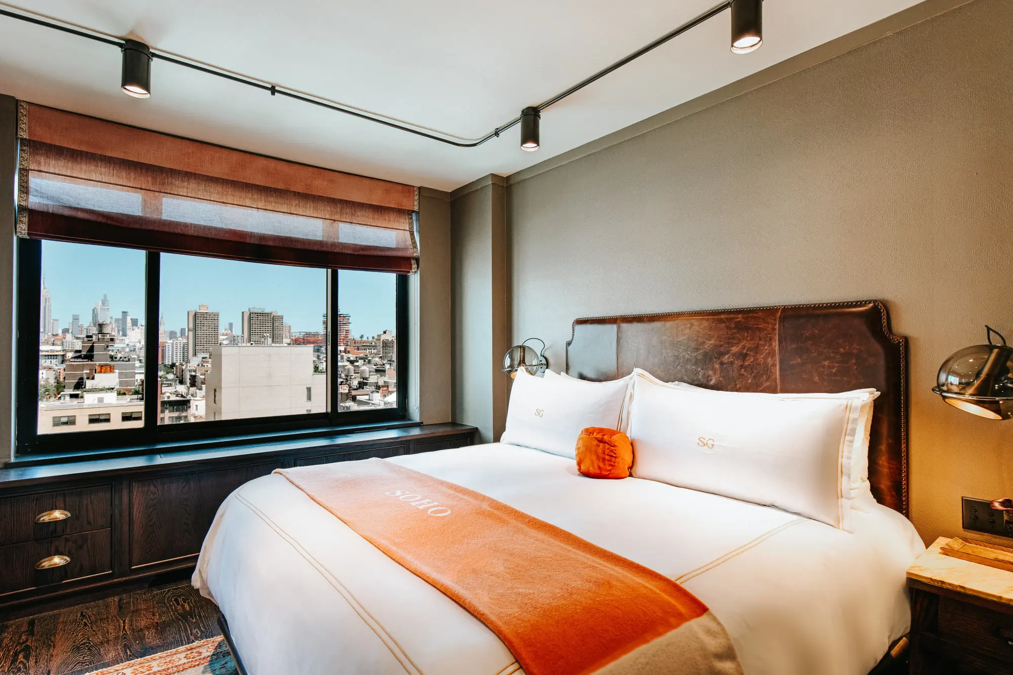 Plush bedding, a great view, and industrial decor in a room